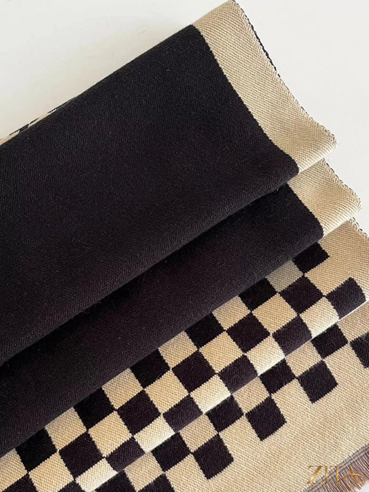 Checkered raw hem scarf by Zita La Belle Elite featuring a stylish checkered pattern and frayed raw edges.