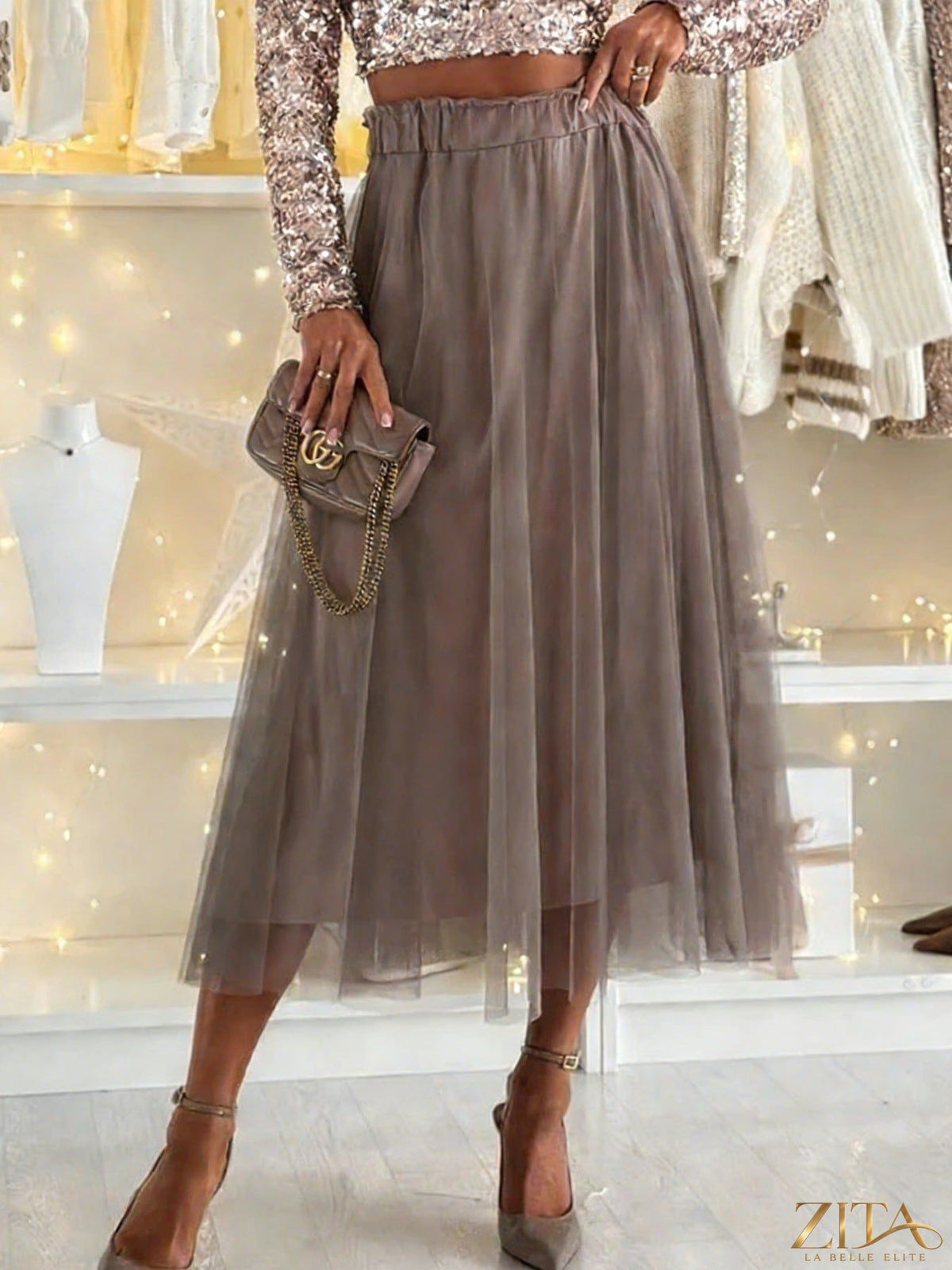 Tulle A-line midi skirt in soft fabric with a flowy silhouette, styled for a chic, feminine look.