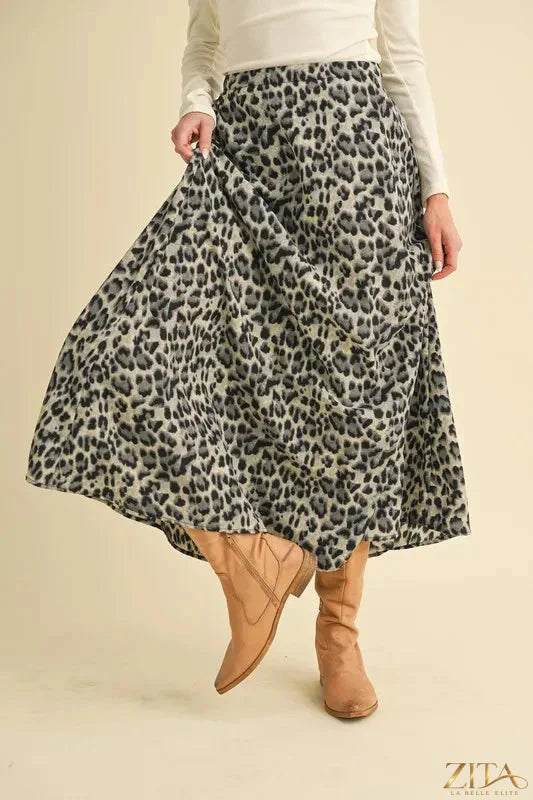 Aemi+Co leopard midi skirt featuring a stylish animal print, high-waisted fit, and flowy fabric for a trendy, fashionable look.