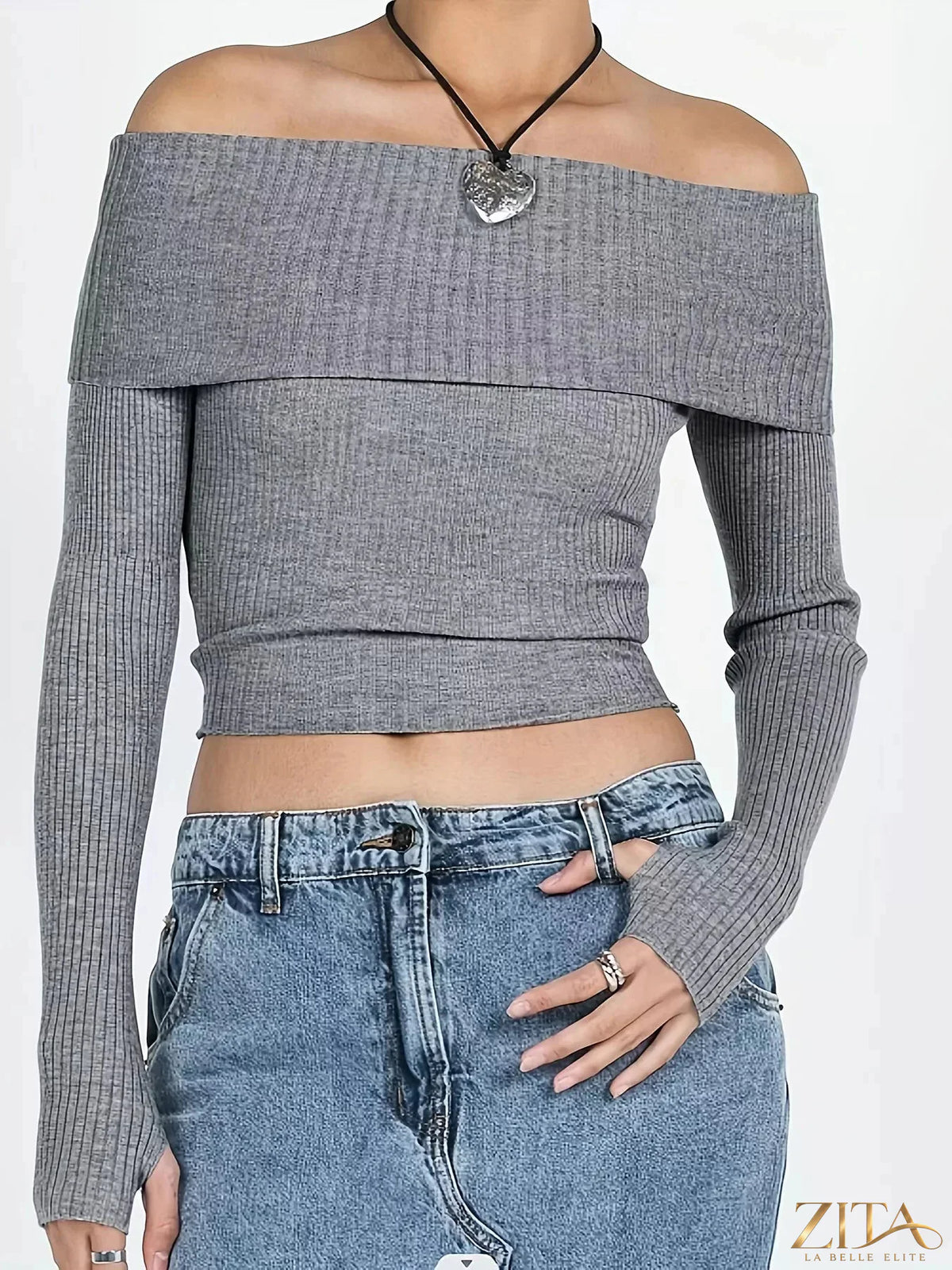 Off-shoulder ribbed knit sweater from Trendsi, showcasing its stylish design and cozy texture in a close-up view.