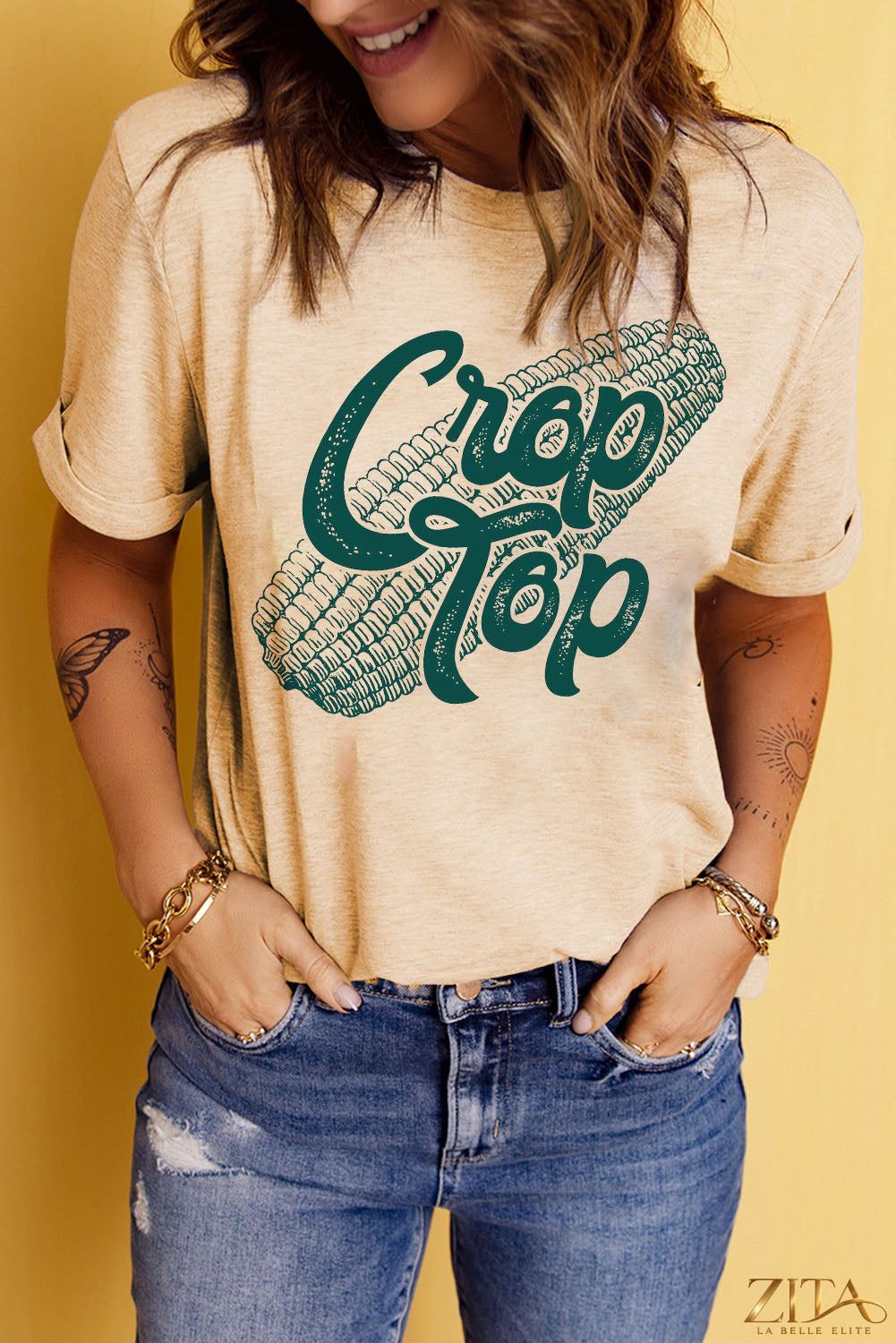 Black Corn Letter Graphic Cuffed T-Shirt by Trendsi featuring a bold corn letter design and cuffed short sleeves.