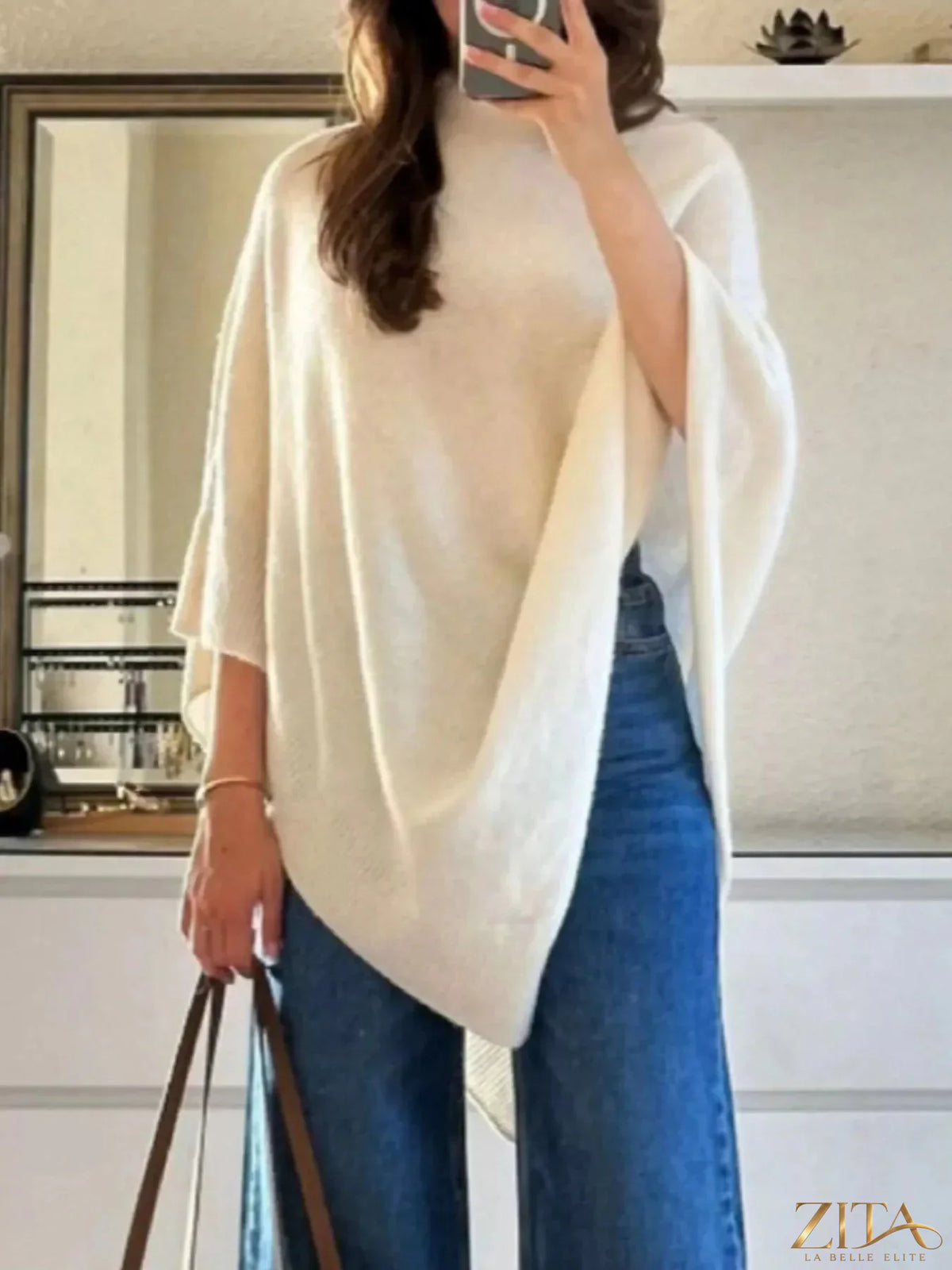 Loose knit turtleneck sweater poncho by Trendsi, featuring a cozy, oversized design with a high neckline and textured knit pattern.