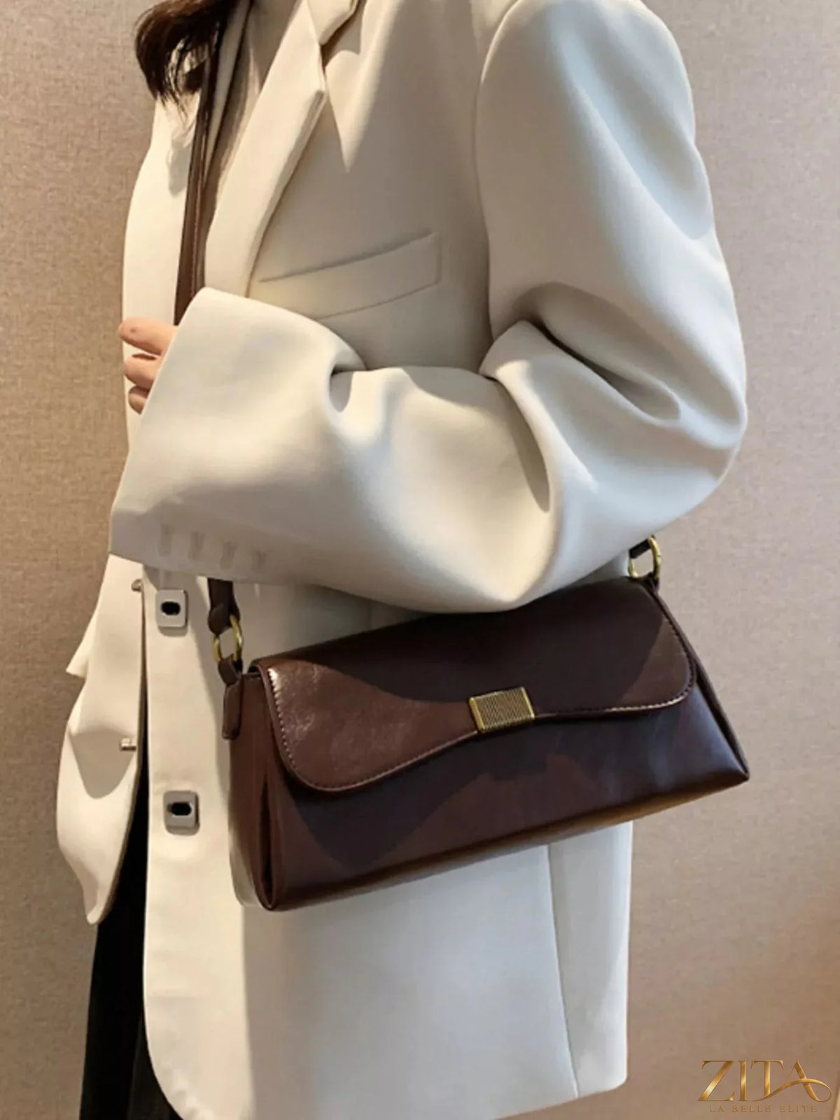 Leather flap shoulder bag by Trendsi featuring a sleek design with a top handle and adjustable shoulder strap.