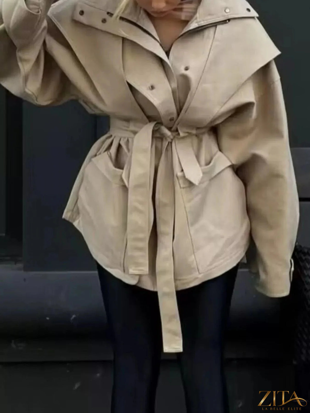 Zita La Belle Elite tie waist snap down trench coat displayed on a hanger, showing classic double-breast design and belt detail.