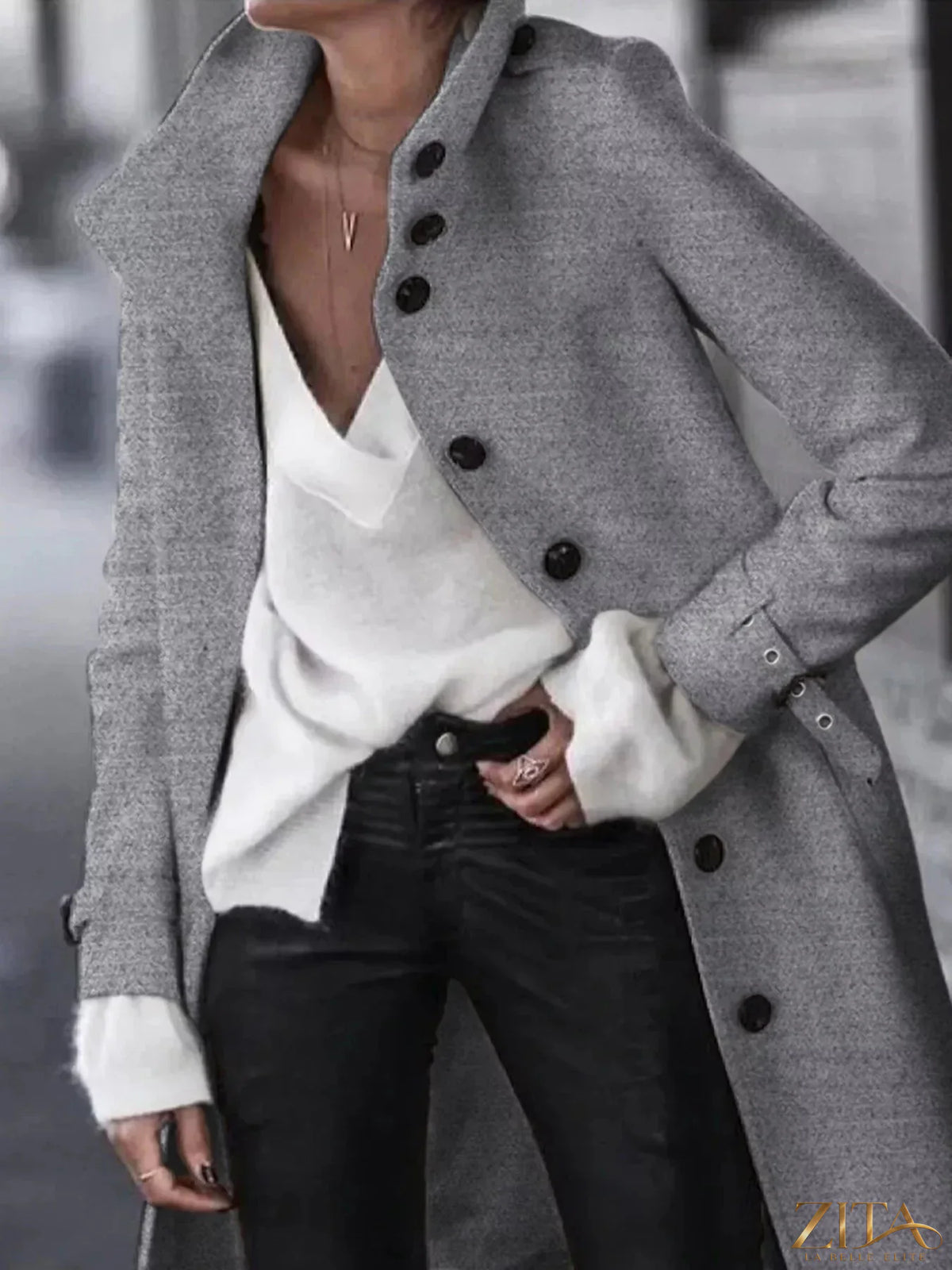 Zita La Belle Elite button-down longline coat with belt, black fabric, tailored fit, and collar, displayed on a hanger.