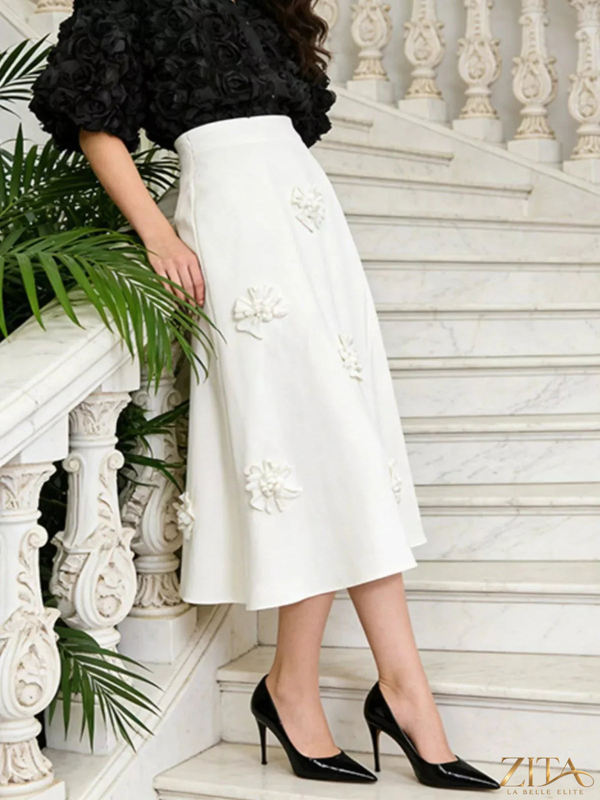 Floral embellished midi skirt by Trendsi featuring a flowy fabric and vibrant floral embroidery on a stylish length.