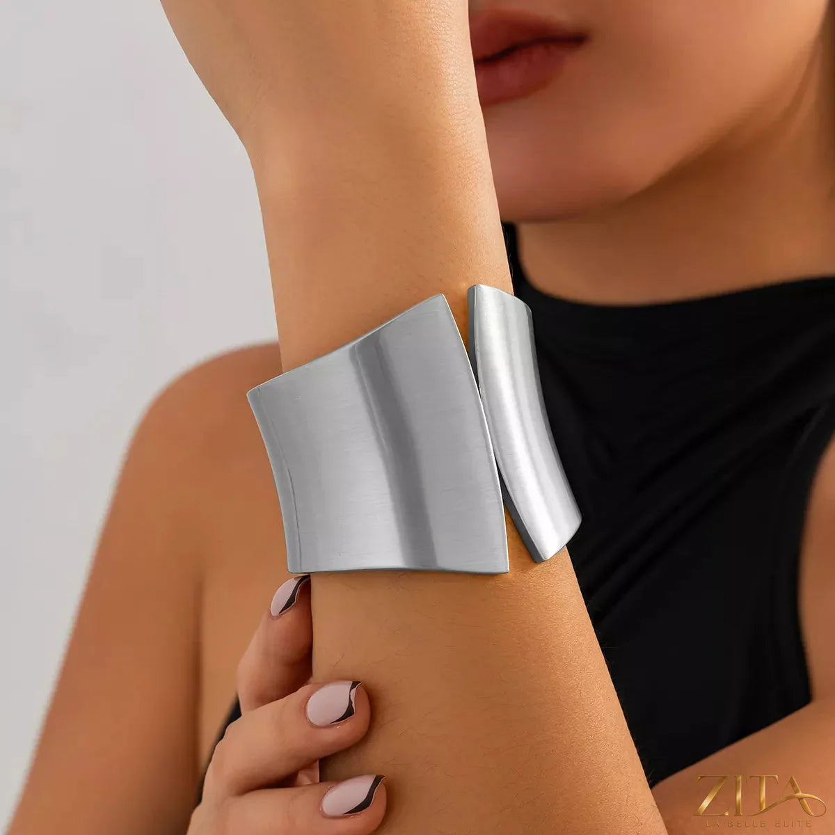 Wide cuff bracelet by Zita La Belle Elite featuring a sleek, modern design in polished metal, worn on a model's wrist.