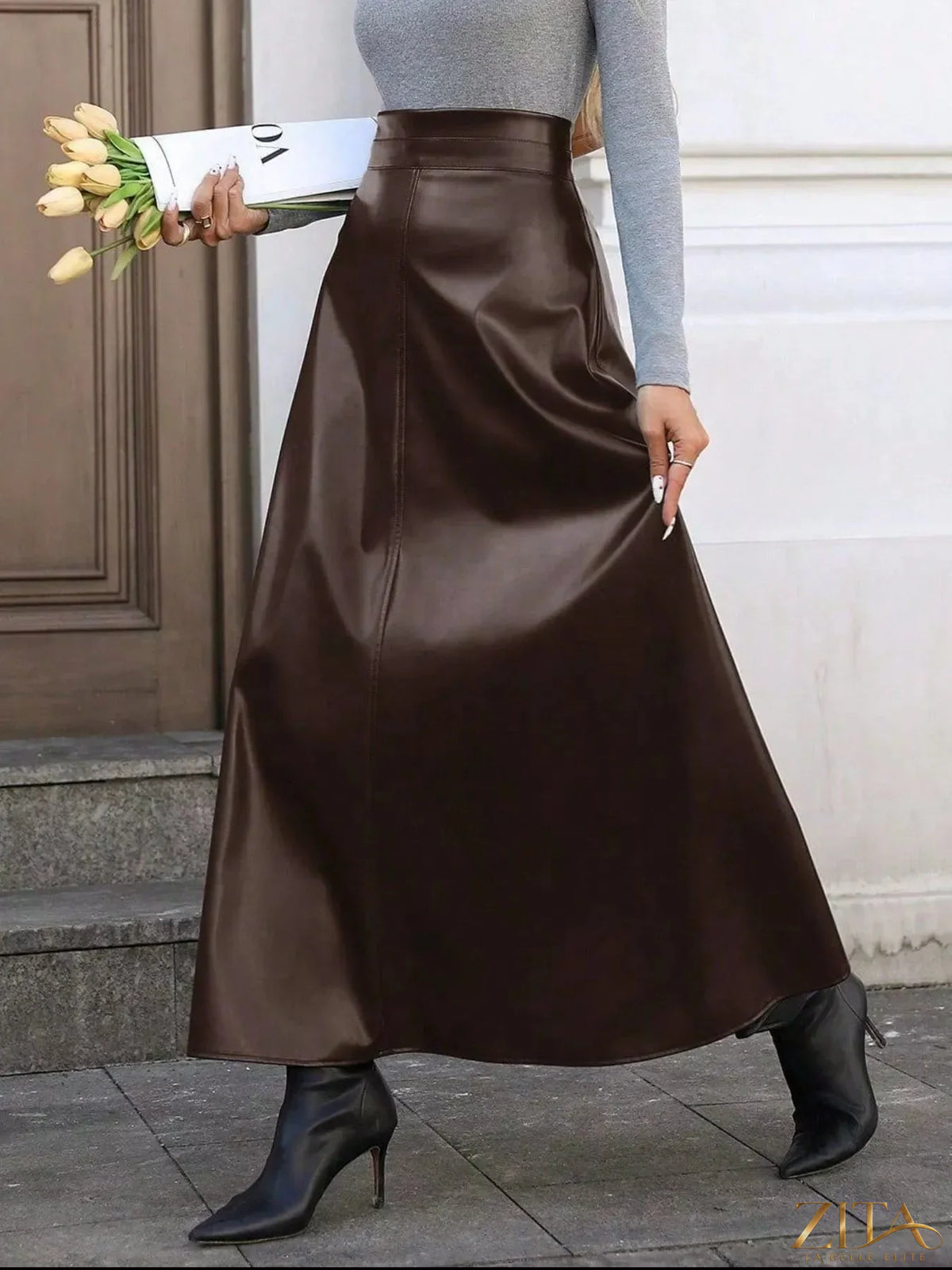 Leather A-Line midi skirt from Trendsi, featuring a smooth leather texture and classic A-line silhouette, displayed on a mannequin.
