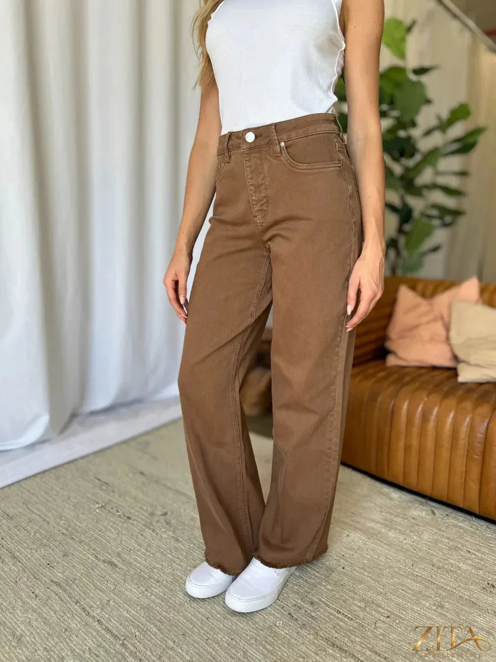 Zita La Belle Elite RFM full size high-rise garment dye wide-leg jeans hanging on a rack.