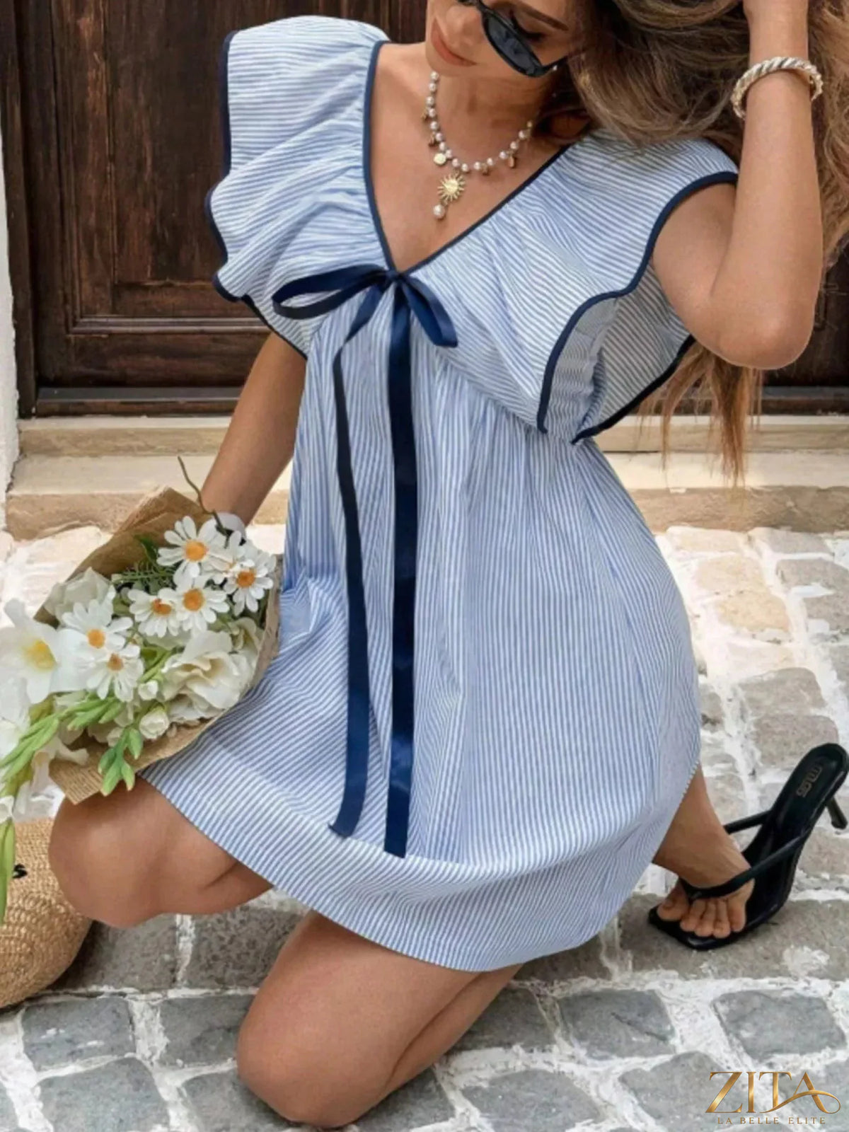 Striped ruffle sleeve mini dress by Trendsi featuring a fitted bodice, playful ruffle sleeves, and a stylish mini length.