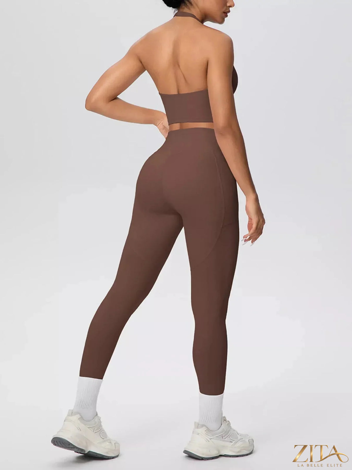 Zita La Belle Elite halter neck crop top and high-waisted leggings active set, shown in black on a model.
