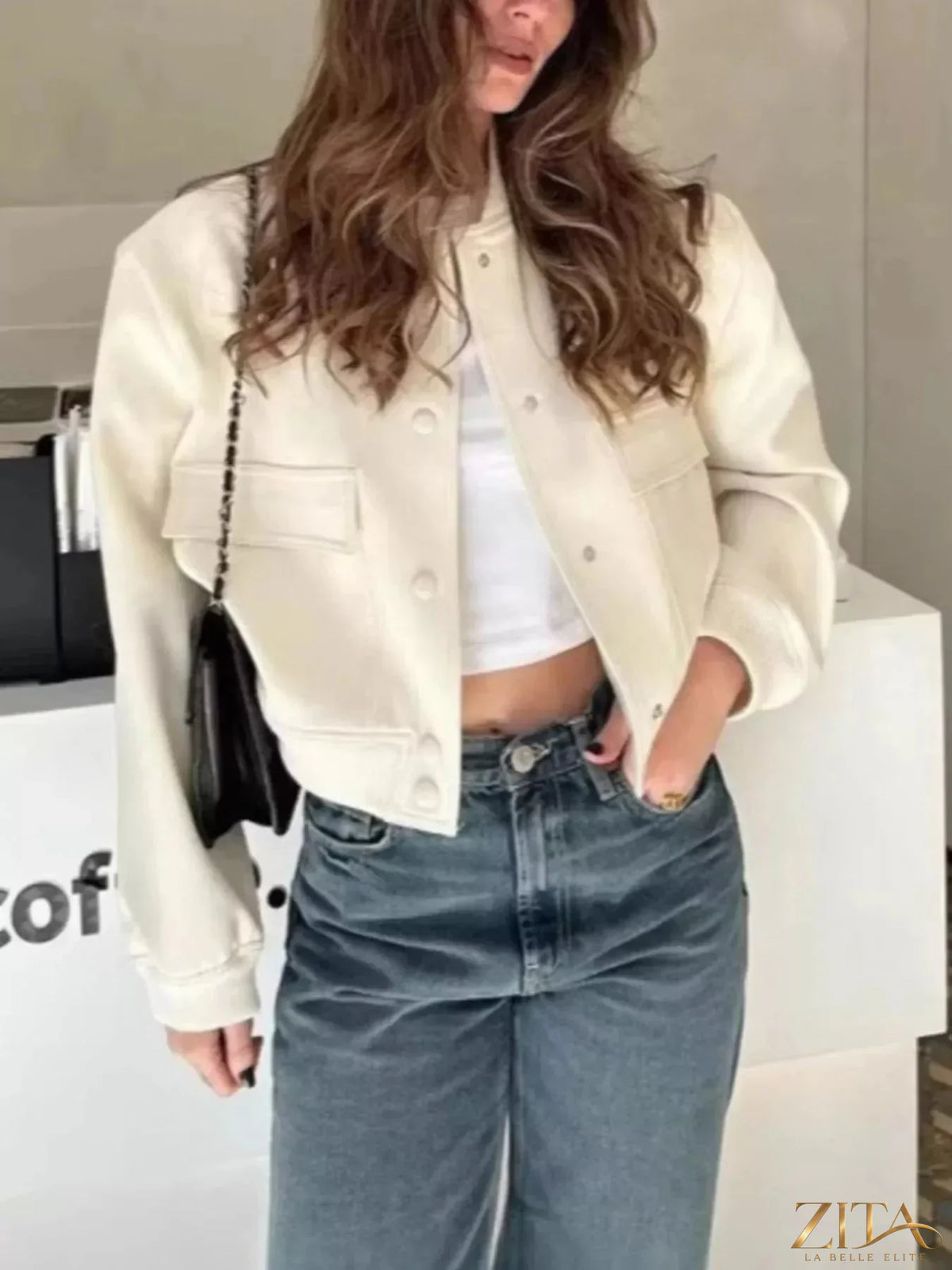 Zita La Belle Elite snap-down cropped bomber jacket with a zip front and ribbed cuffs, displayed on a hanger.