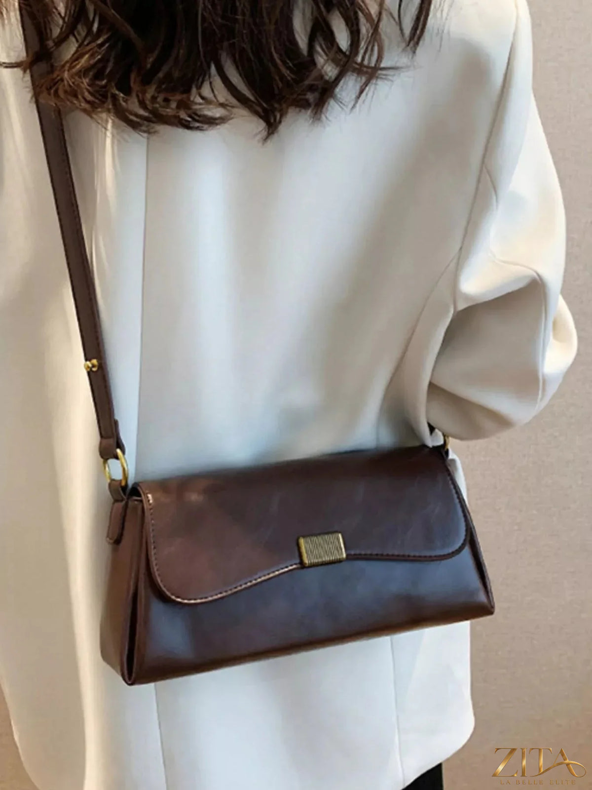 Leather flap shoulder bag by Trendsi featuring a sleek design and adjustable strap, perfect for casual or formal wear.