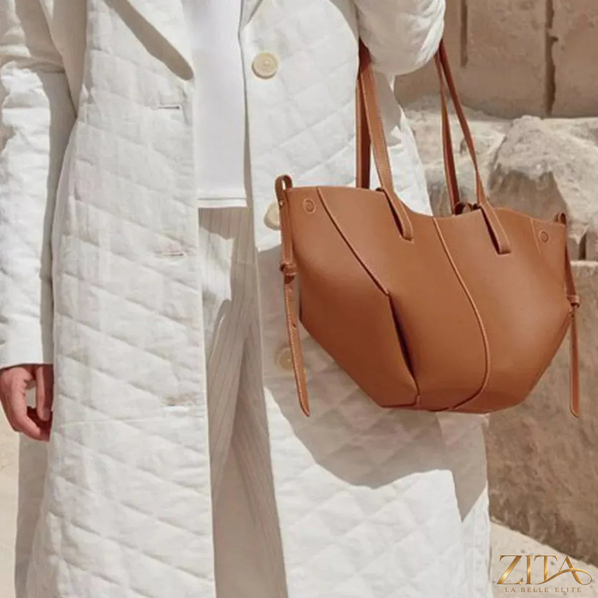 Trendsi PU leather tote bag with sturdy handles and spacious interior, showing its sleek, minimalist design in black.