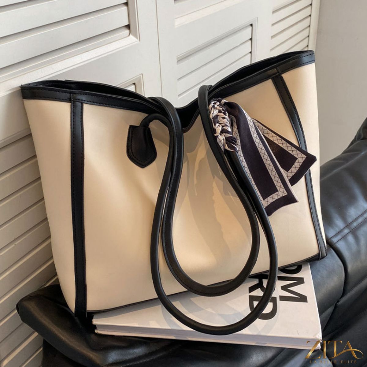 Contrast tote bag by Zita La Belle Elite with black and white color blocks, featuring sturdy handles and spacious interior.
