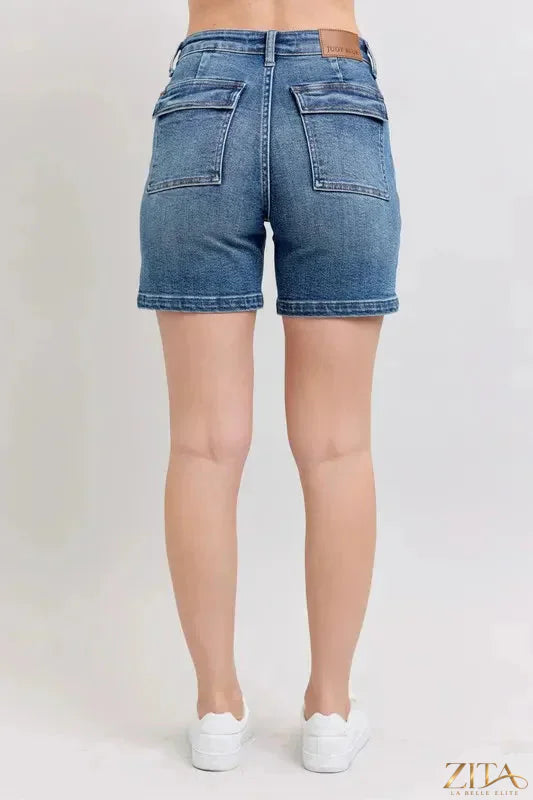 Plus size Judy Blue high rise denim shorts from Zita La Belle Elite, featuring a classic five-pocket design and frayed hem.