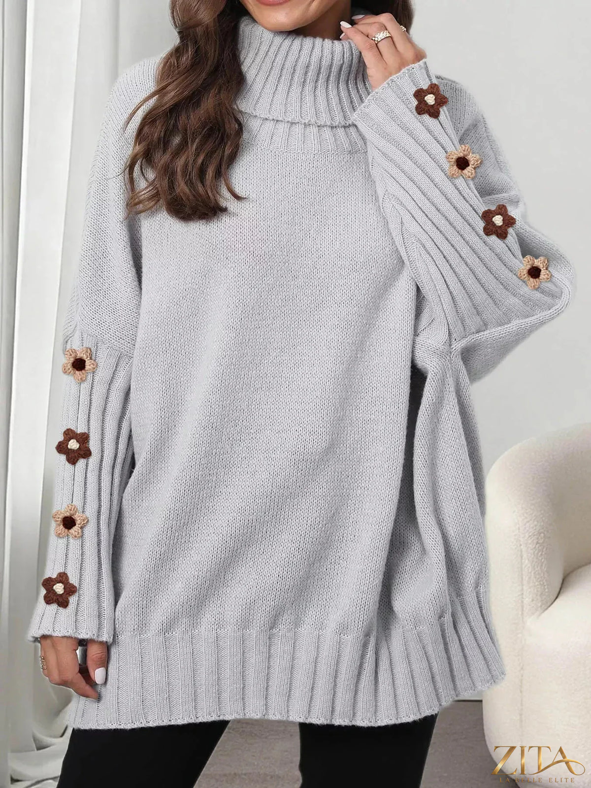 Zita La Belle Elite oversized turtleneck sweater with floral applique sleeves, soft knit fabric, and cozy fit for stylish comfort.