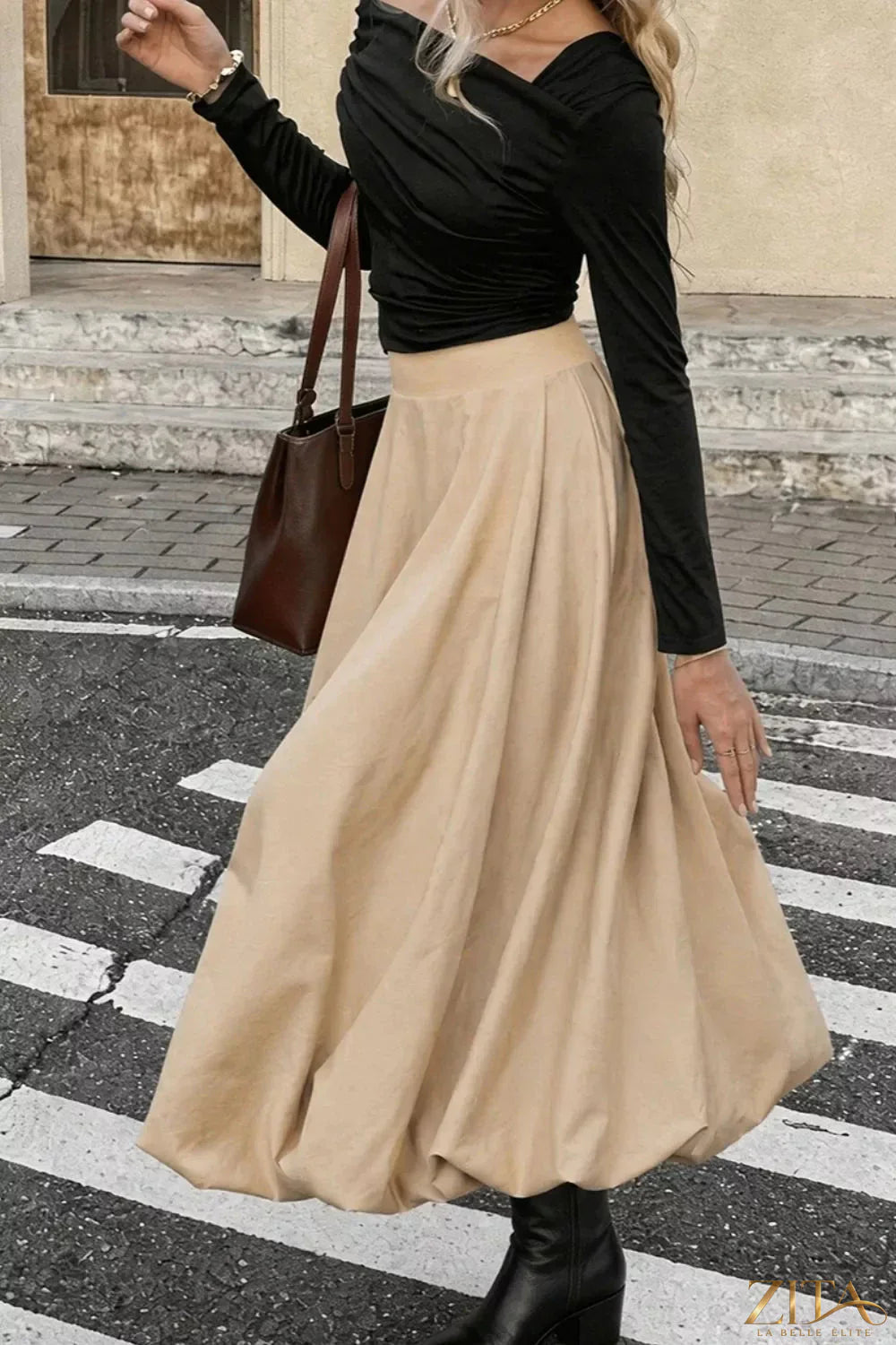 High-waisted A-line midi skirt by Trendsi, featuring a flowy design and classic silhouette, shown in a stylish fabric.
