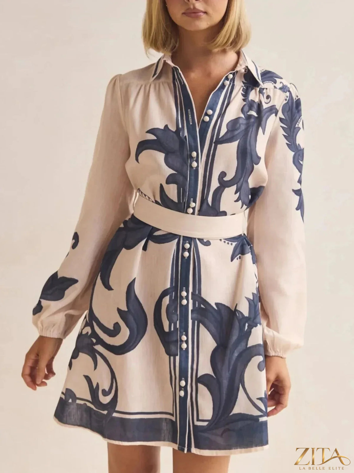 Printed long sleeve shirt dress by Trendsi featuring a stylish design, button front, and relaxed fit for casual wear.