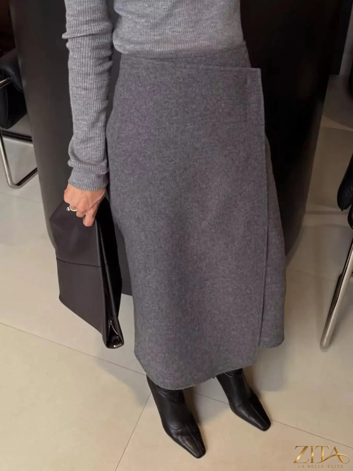High-waisted wrap midi skirt by Trendsi featuring a stylish design and flowy fabric, perfect for casual or dressy outfits.
