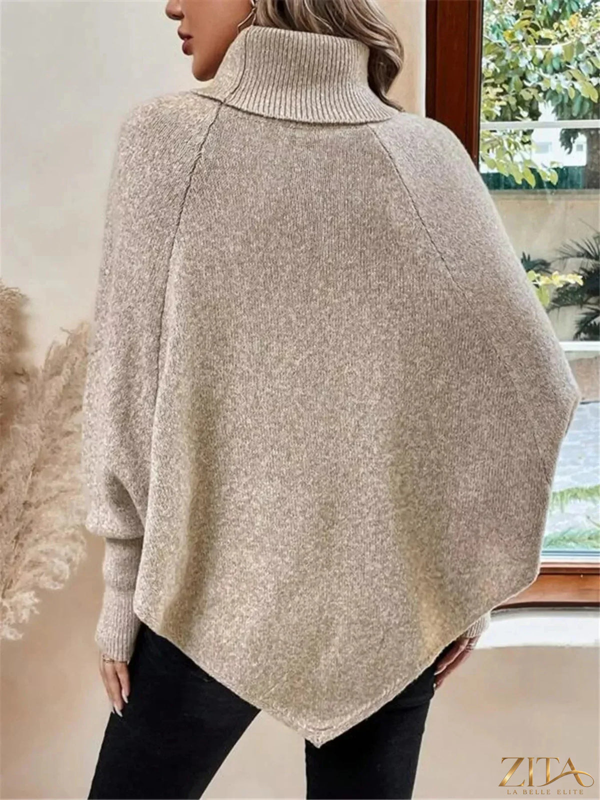 Cable knit turtleneck cape sweater by Trendsi, shown in a cozy, textured knit with a high turtleneck and cape design.