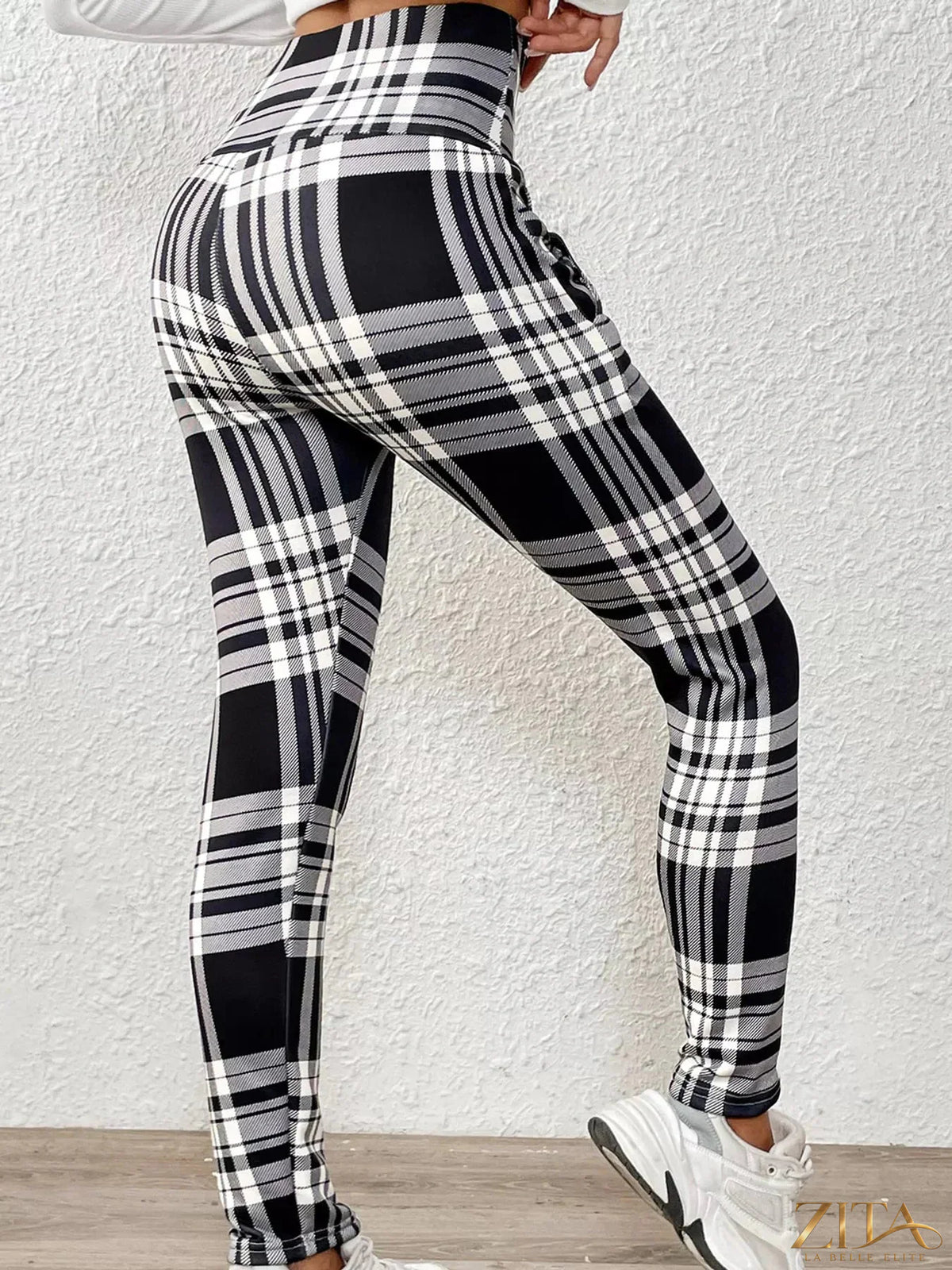 High-waisted plaid slim-fit leggings by Trendsi featuring a stylish checkered pattern and comfortable stretch fit.