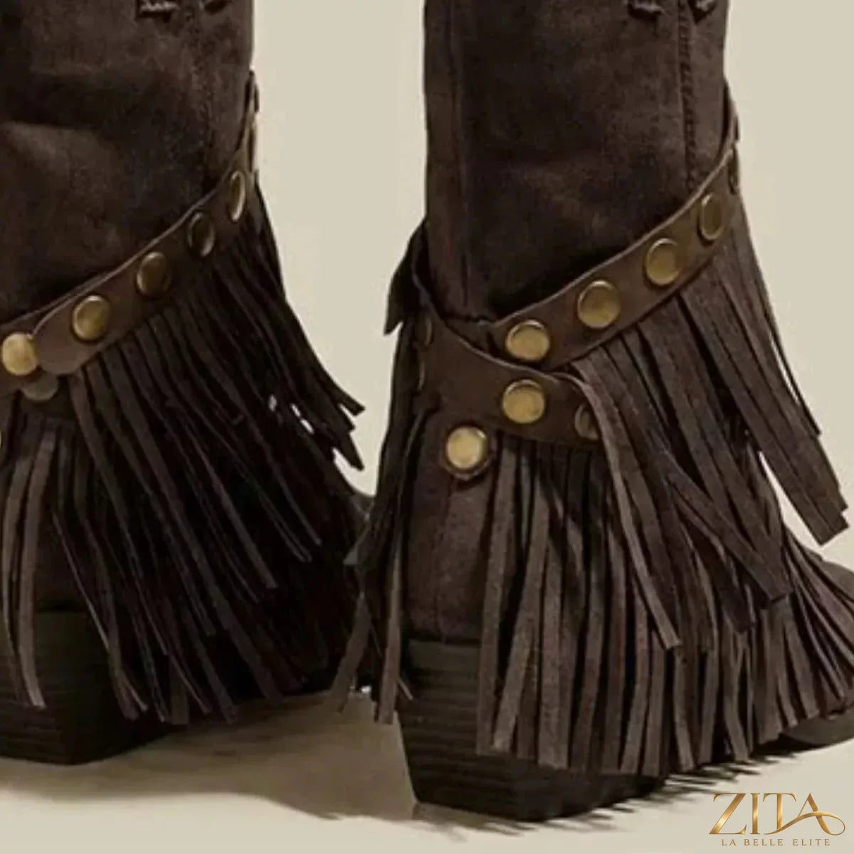 Vintage Zita La Belle Elite suede western fringe boots with studded straps, showcasing detailed fringe and strap design on a tan leather background.