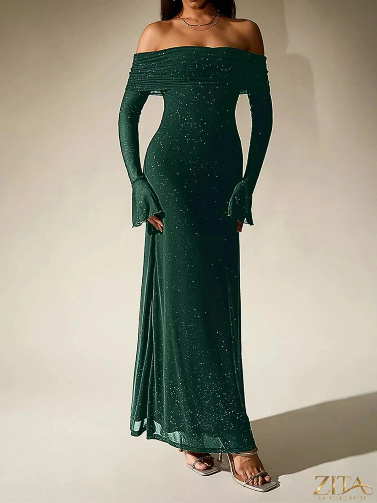 Zita La Belle Elite glitter off-shoulder maxi dress with shimmering fabric and flowing silhouette, fashionably styled on a model.