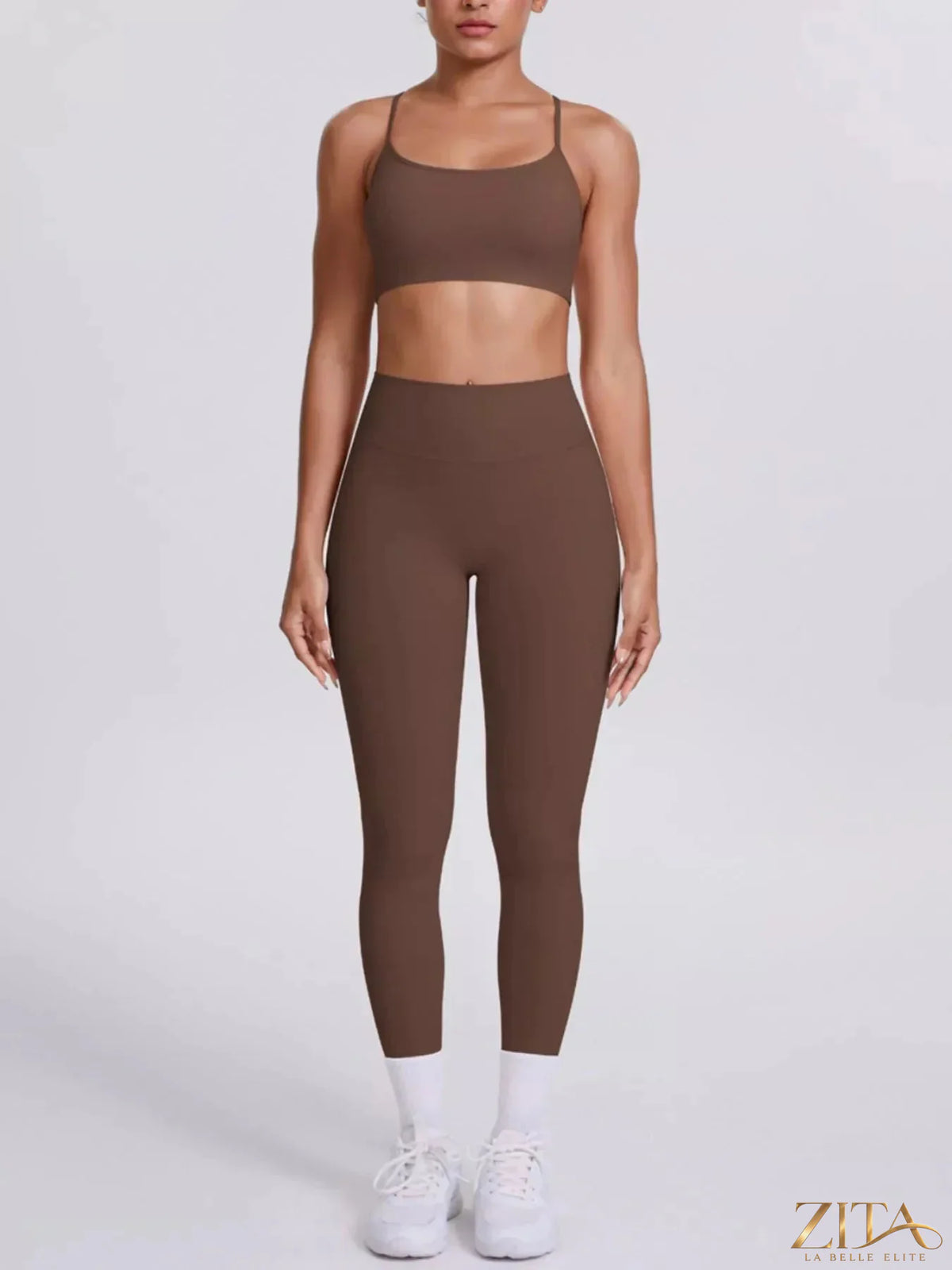Zita La Belle Elite criss-cross back cami and matching black leggings active set on a hanger, close-up of fabric and design details.