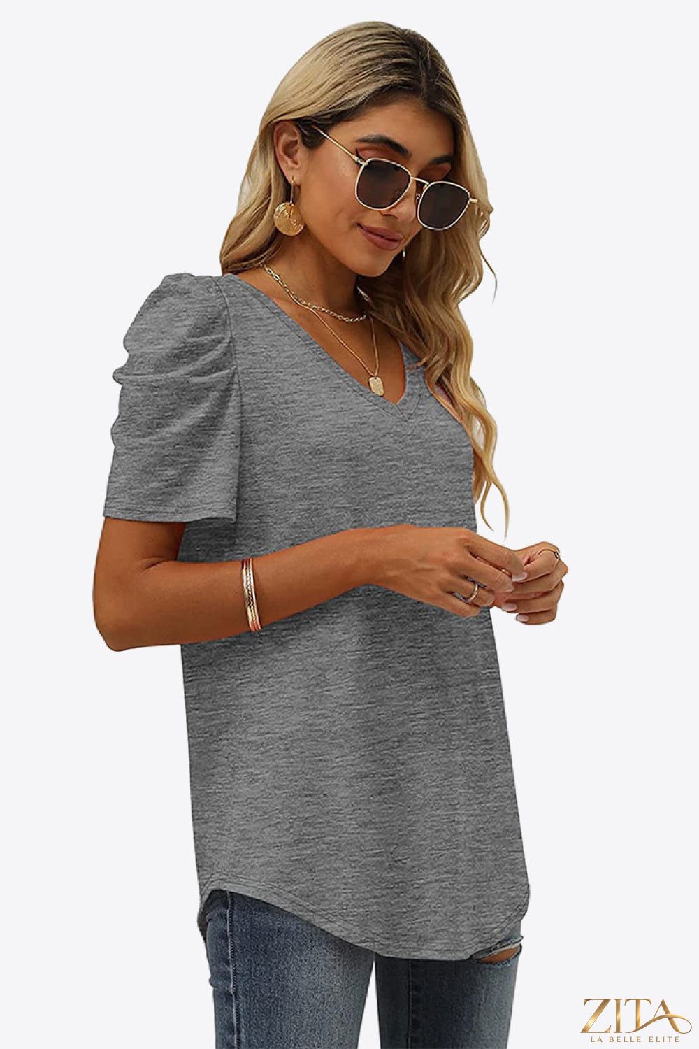 V-neck puff sleeve tee by Trendsi featuring a fitted silhouette and lightweight fabric, with soft puffed sleeves and a classic neckline.