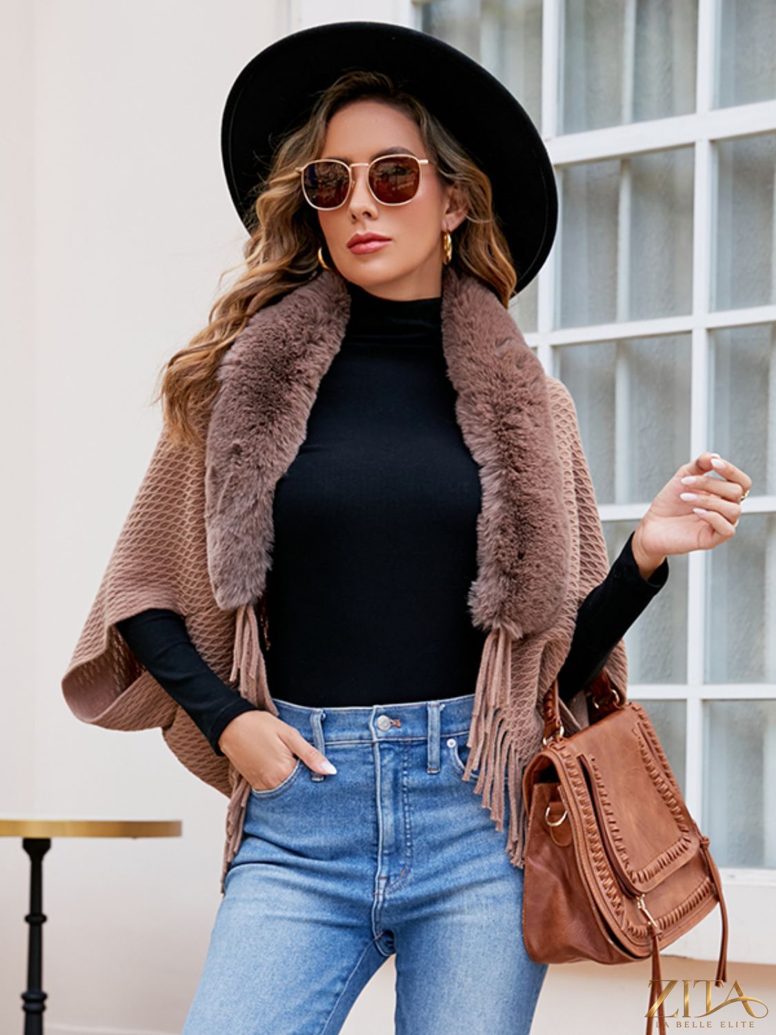 Open front fringe hem poncho by Trendsi featuring a flowing design with fringe details, draped over a neutral outfit.