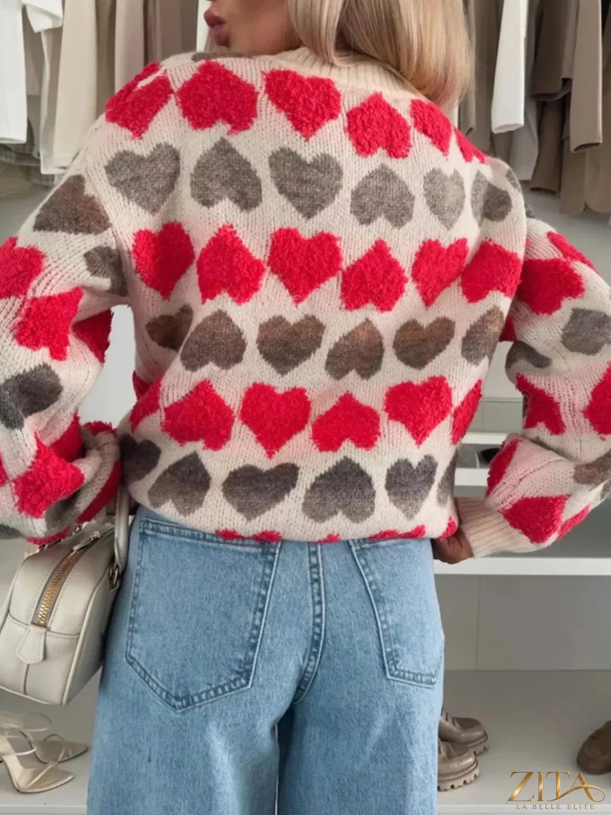 Heart-patterned round neck sweater by Zita La Belle Elite, featuring a cozy knit with red heart designs on a soft fabric.
