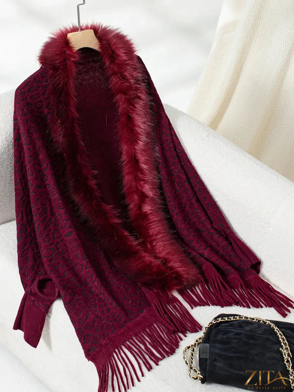 Leopard print fringe open front long sleeve poncho from Trendsi, featuring a stylish design with fringe details and a relaxed fit.