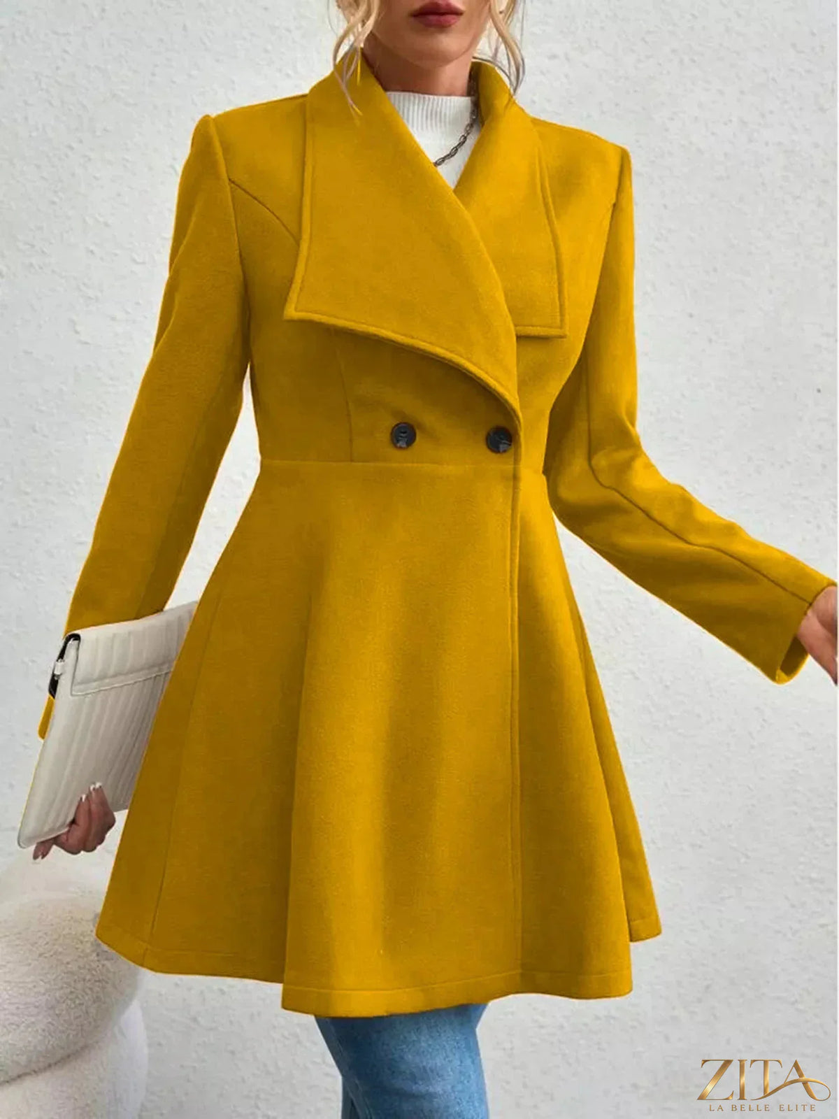 Zita La Belle Elite double-breasted wool blend coat hanging on a wooden rack, showcasing classic tailored style and warm fabric.