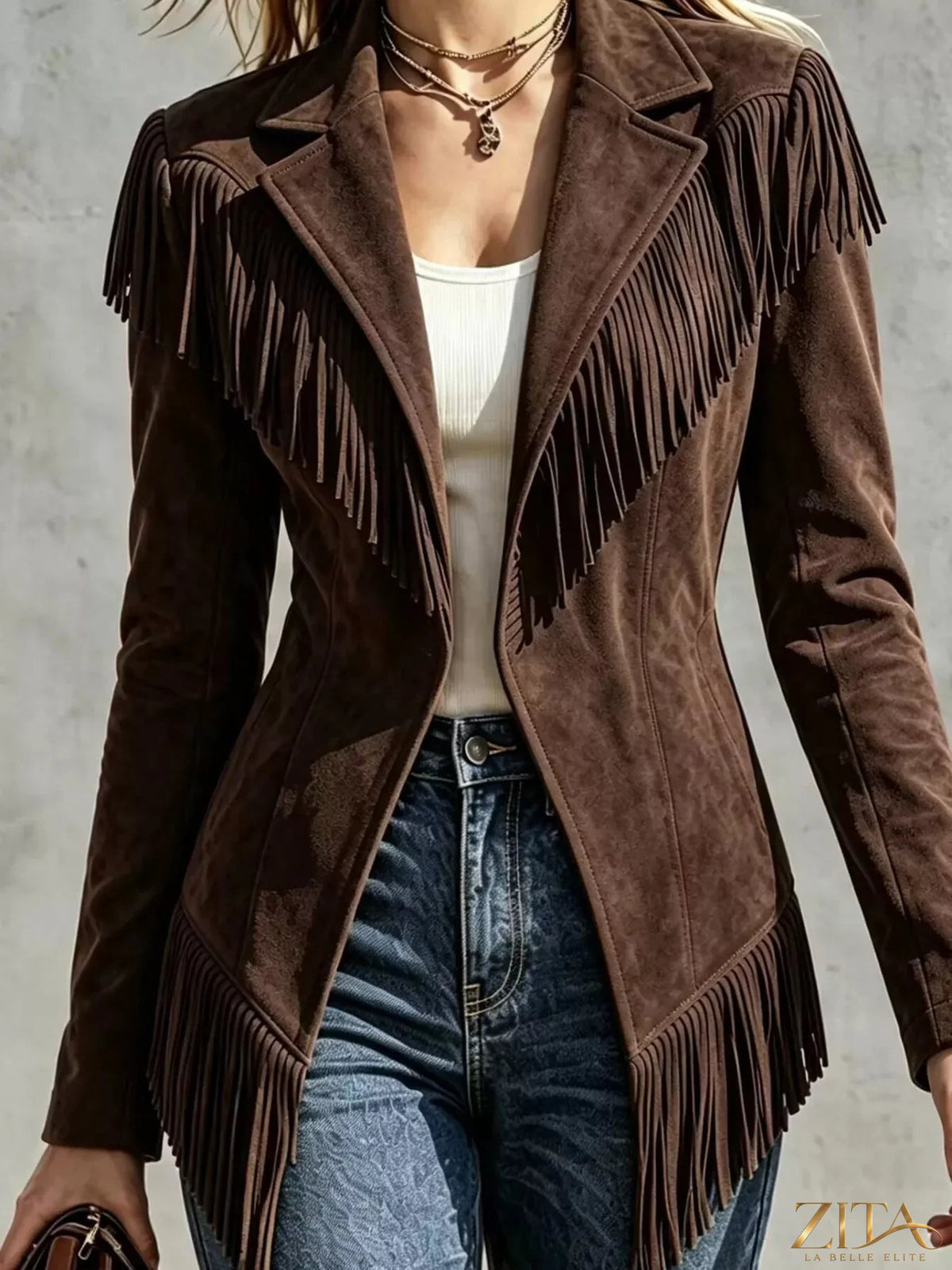 Western-inspired fringed open front jacket with fringe details and tailored fit, stylishly displayed on a neutral background.