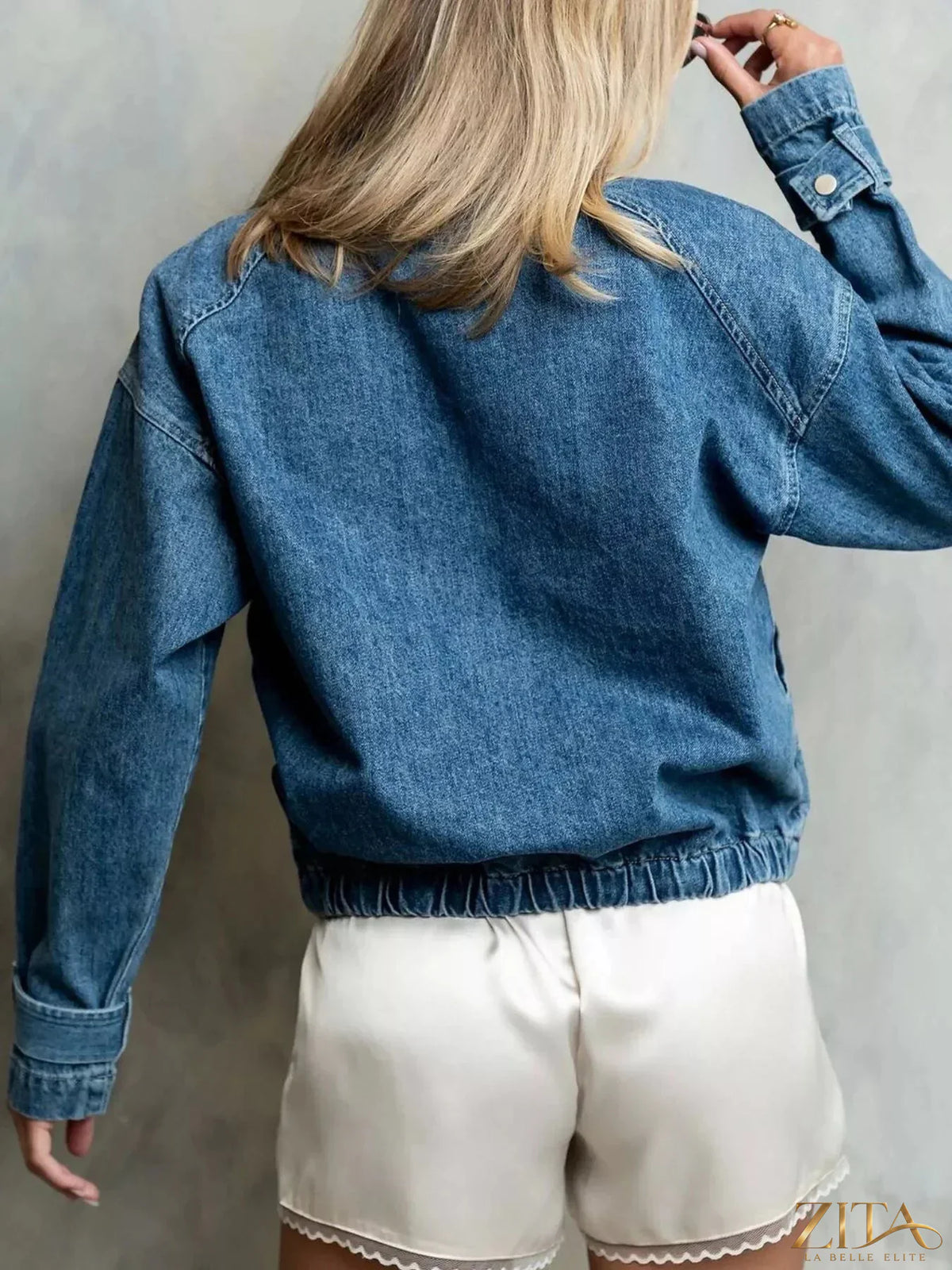Zita La Belle Elite half-zip turtleneck denim top, close-up of navy blue fabric with half-zip neckline and collar detail