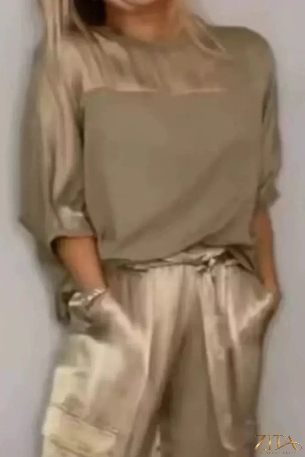 Satin round neck top and pants set by Trendsi, featuring a smooth, shiny fabric and relaxed fit for stylish comfort.