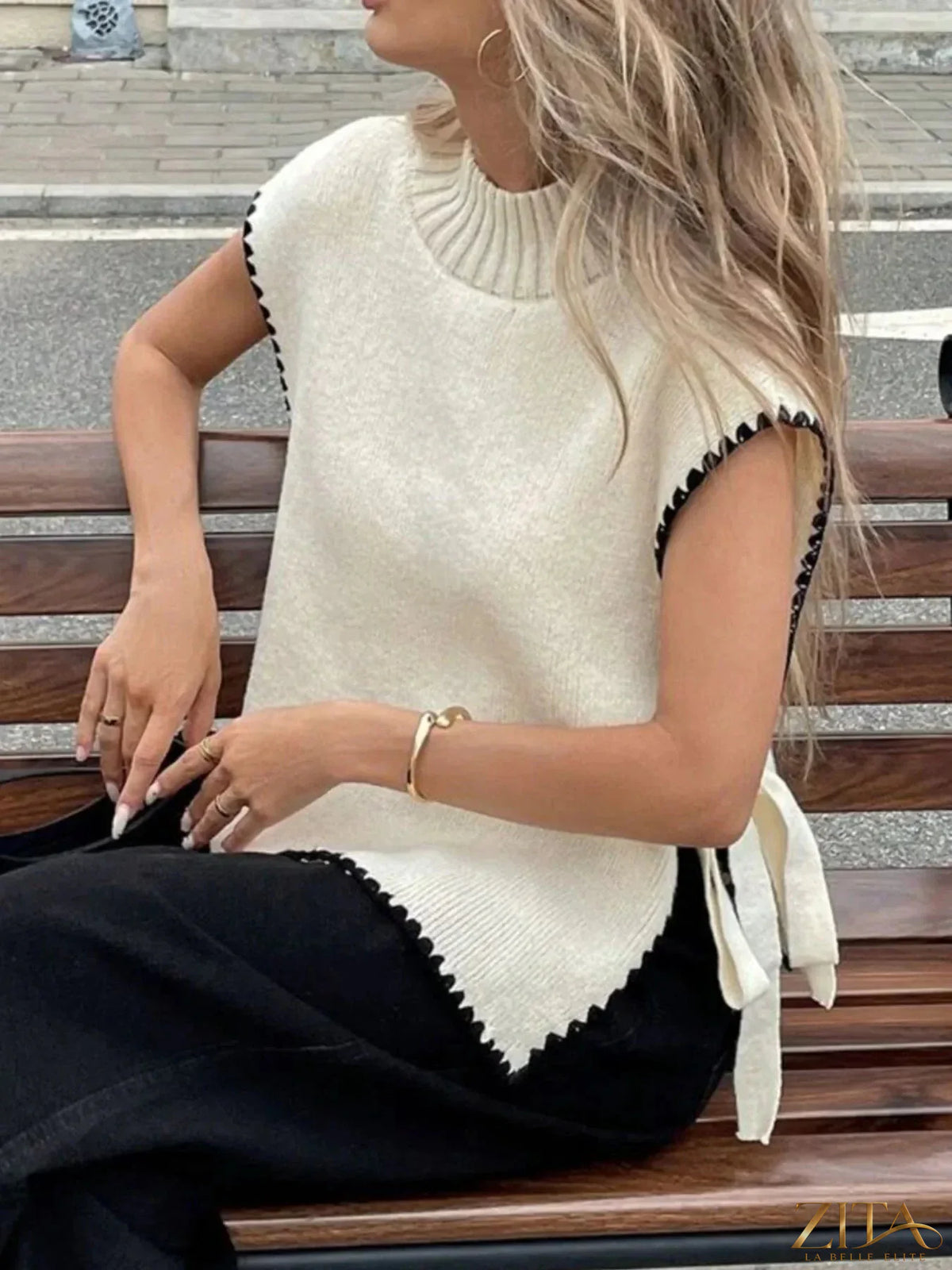 Ribbed turtleneck sweater vest with contrast trim in black and white, styled with layered look, from Trendsi.