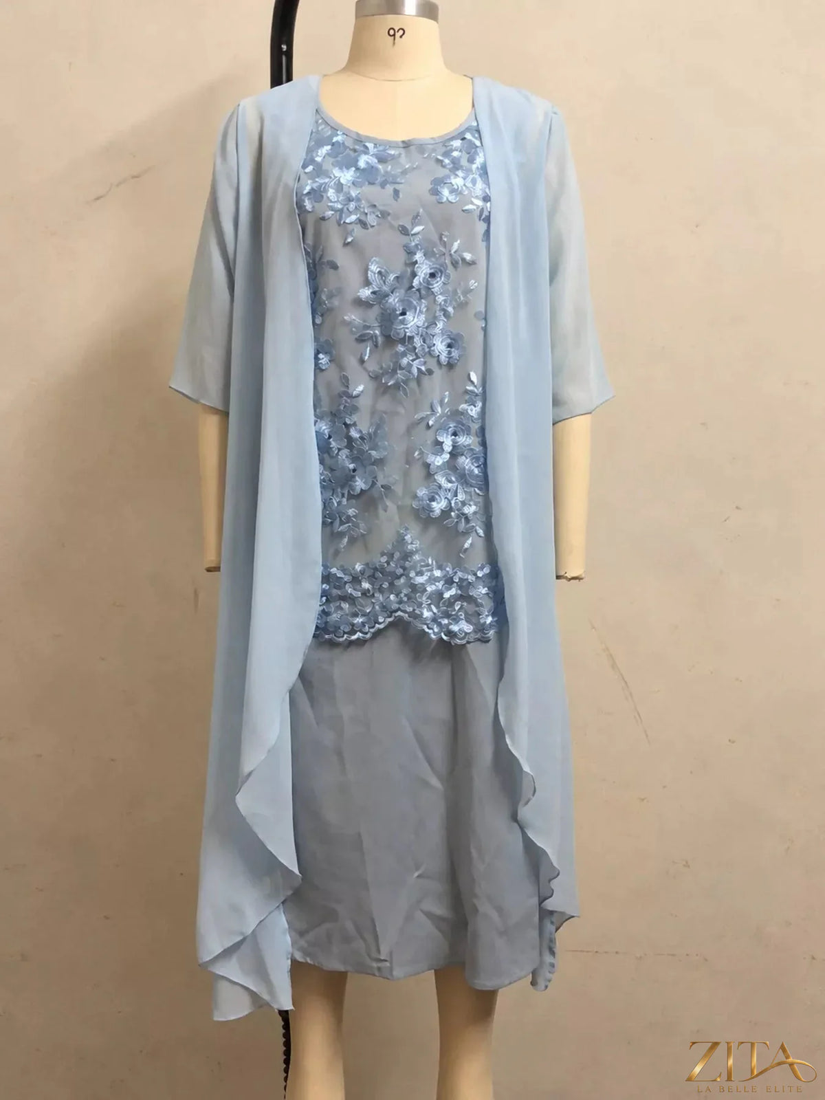 Plus size elegant lace overlay dress with matching chiffon cardigan set by Zita La Belle Elite, shown on a model.