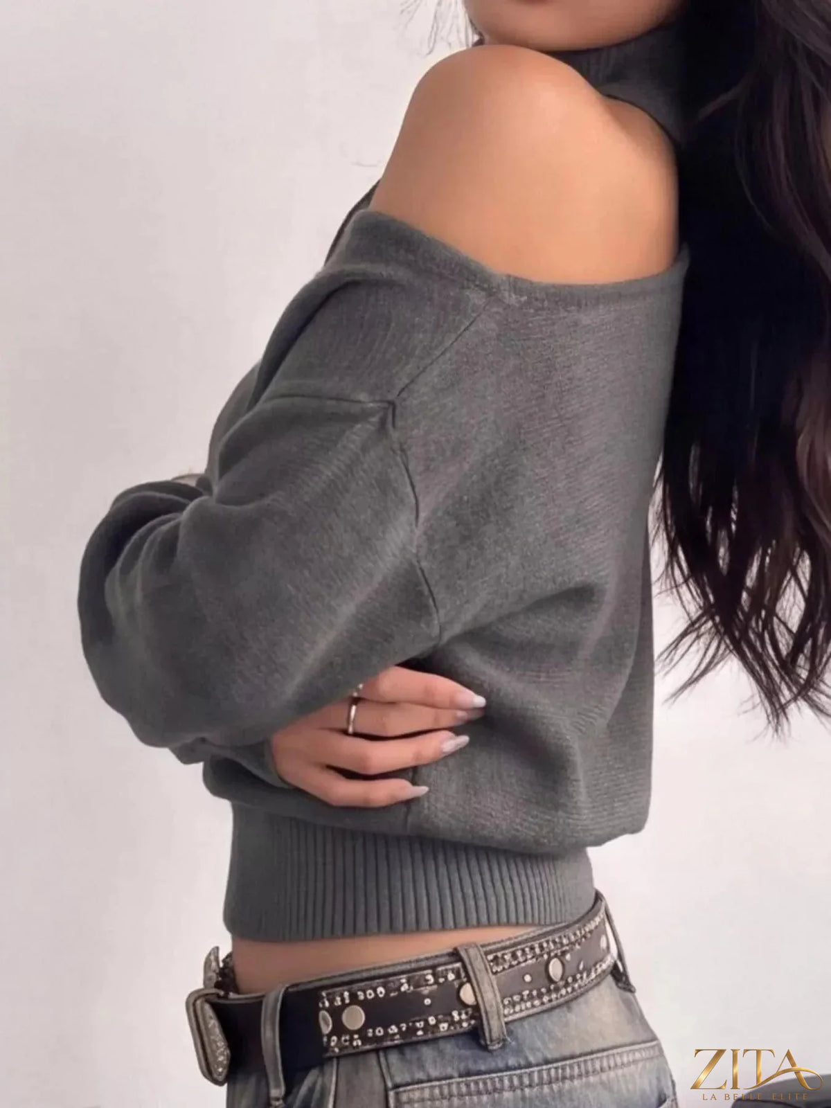 Cold-shoulder dropped shoulder sweater by Trendsi, featuring a cozy knit fabric, relaxed fit, and stylish cut-out shoulder design.