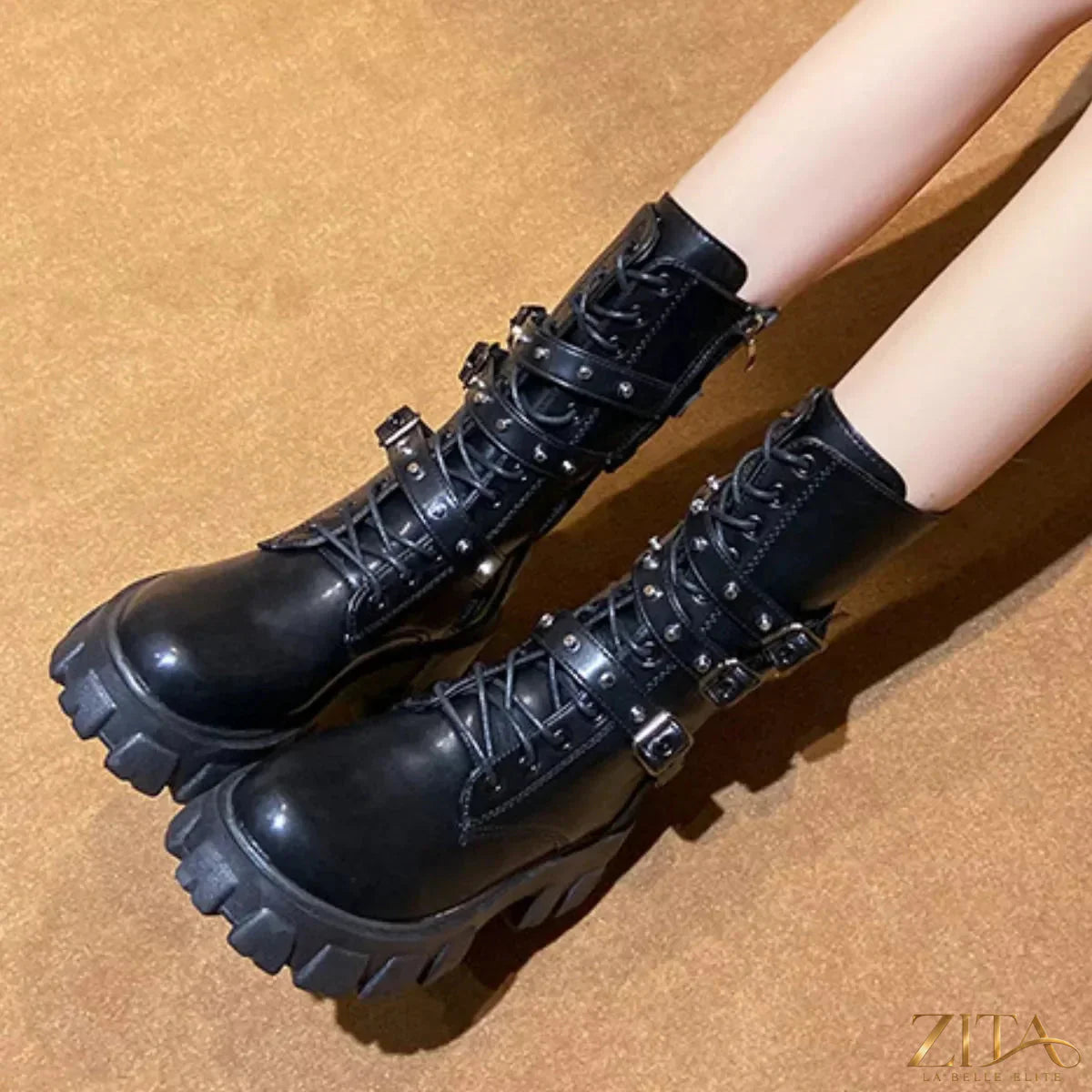 Black lace-up combat boots with buckled straps from Trendsi, featuring sturdy soles and a rugged, stylish design.