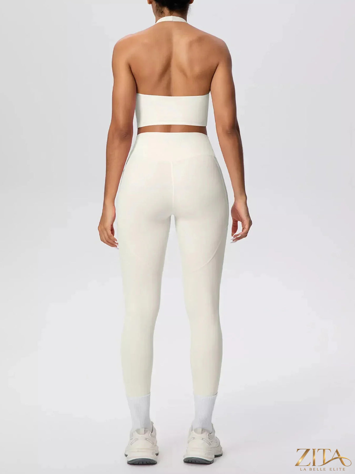 Zita La Belle Elite halter neck crop top and high-waisted leggings active set, black, stretchy fabric, close-up on the outfit.