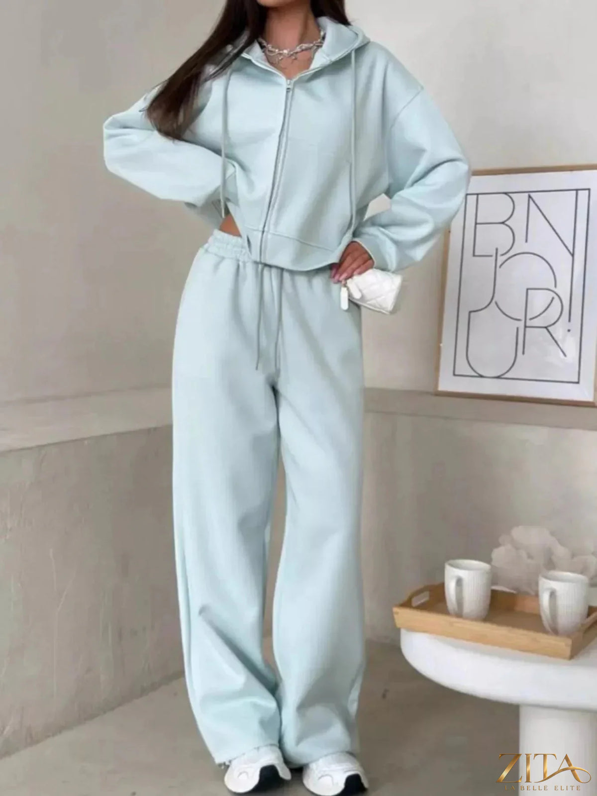 Zita La Belle Elite zip-up hoodie and wide-leg pants set, in soft fabric, displayed on a hanger with neutral background.