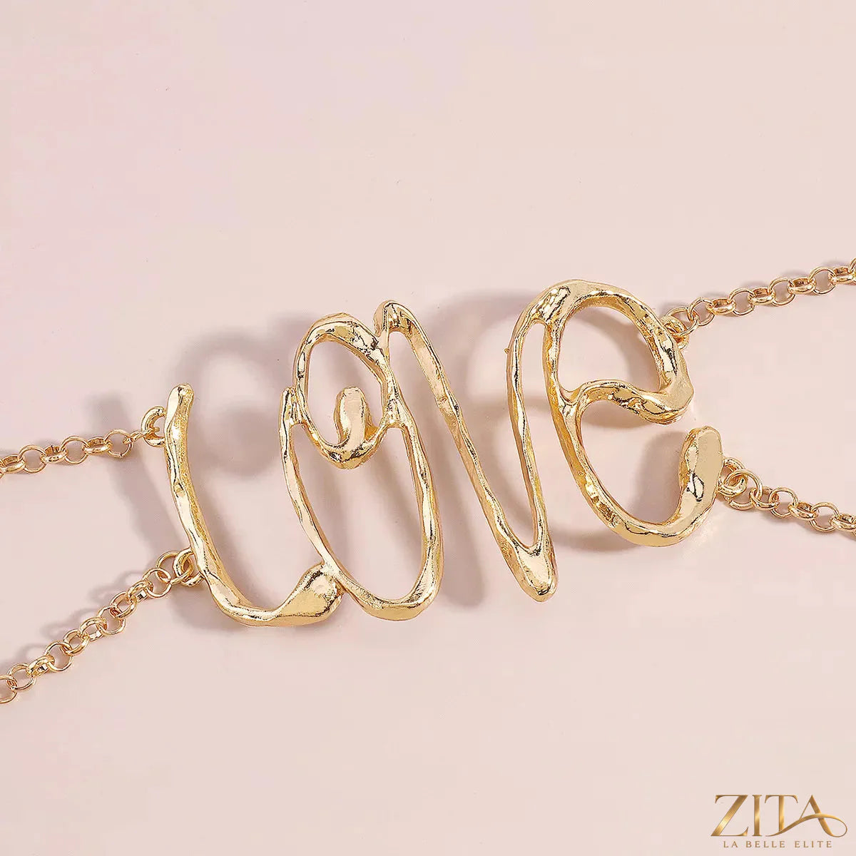 Gold wire love script statement necklace by Zita La Belle Elite featuring elegant, handcrafted gold wire lettering on a delicate chain.