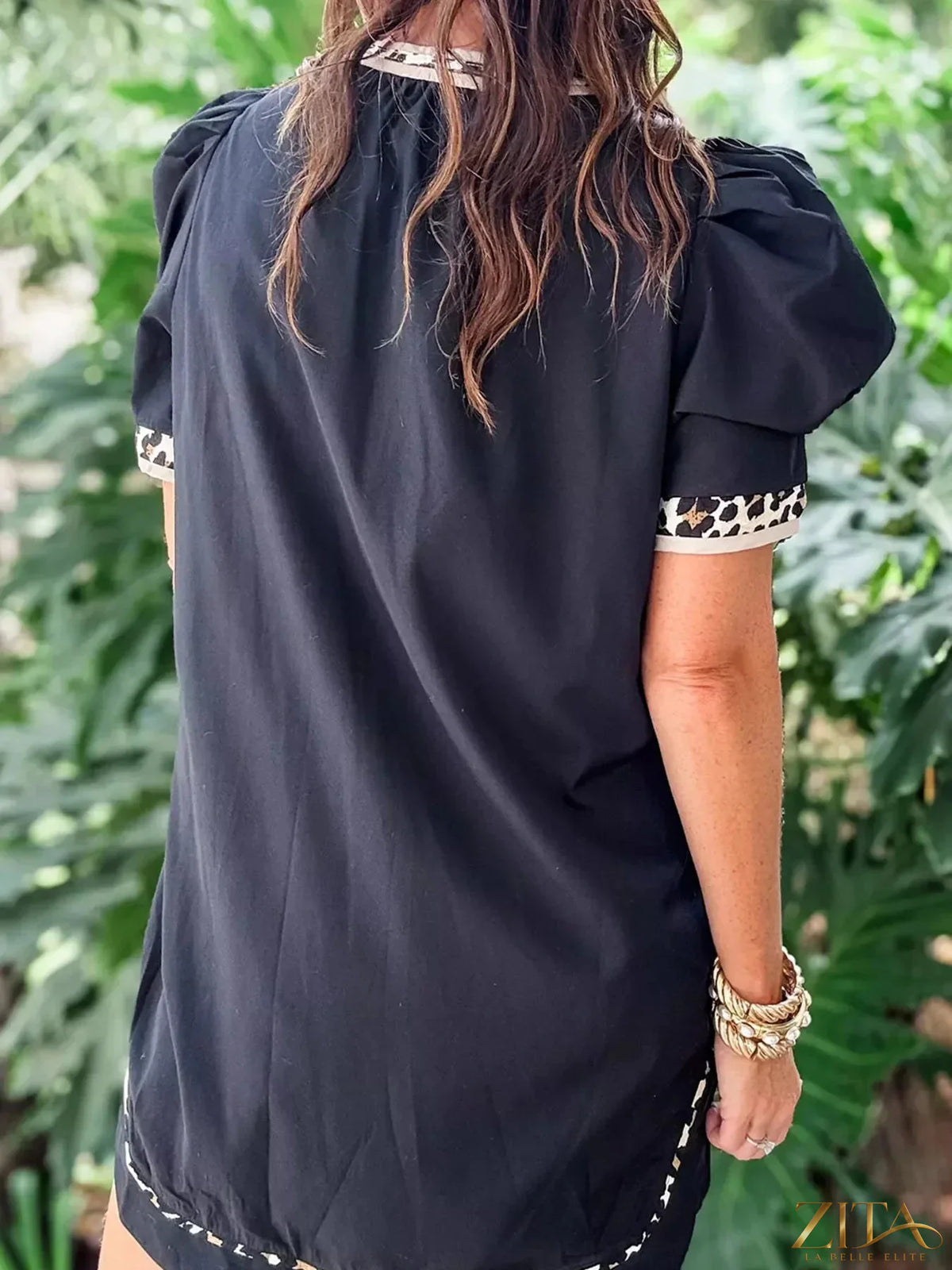 Notched puff sleeve mini dress by Trendsi featuring a stylish silhouette and feminine design, shown on a model.