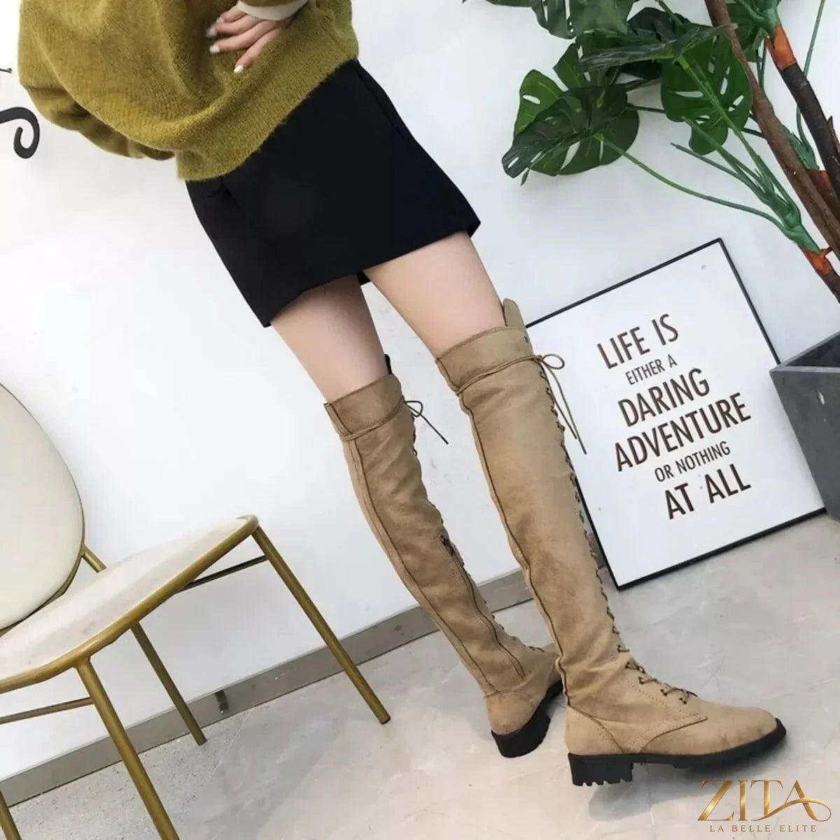 Over-the-knee lace-up boots from Trendsi featuring black faux leather material and chunky heel for a stylish, bold look.