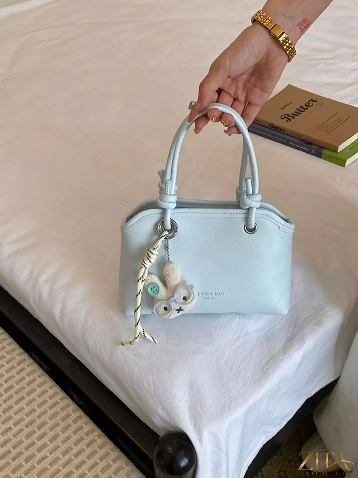 Trendsi PU leather handbag with top handles and gold-tone hardware, showing its sleek, stylish design and textured leather finish.