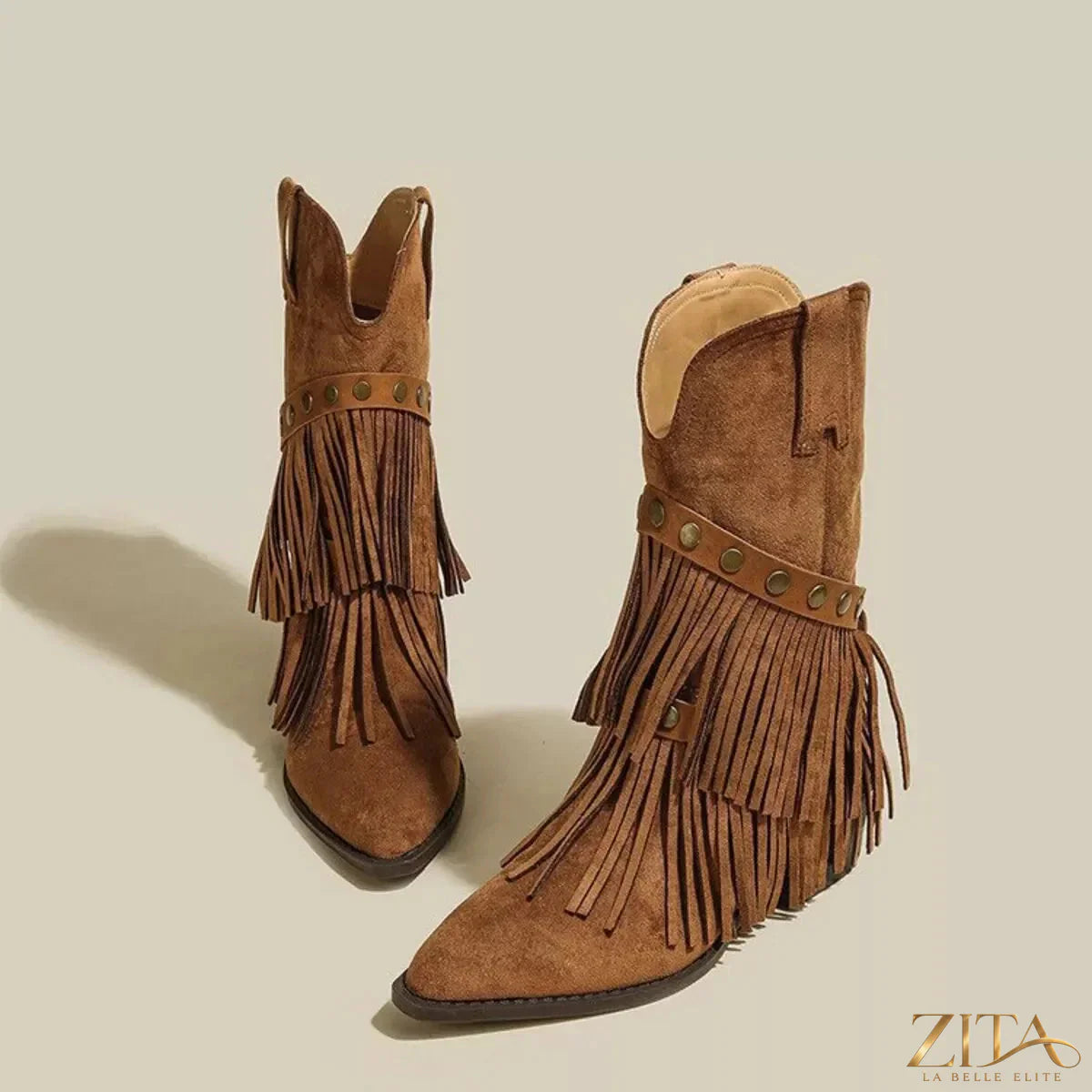 Vintage suede Western fringe boots with studded straps by Zita La Belle Elite, featuring decorative fringe and rugged strap details.