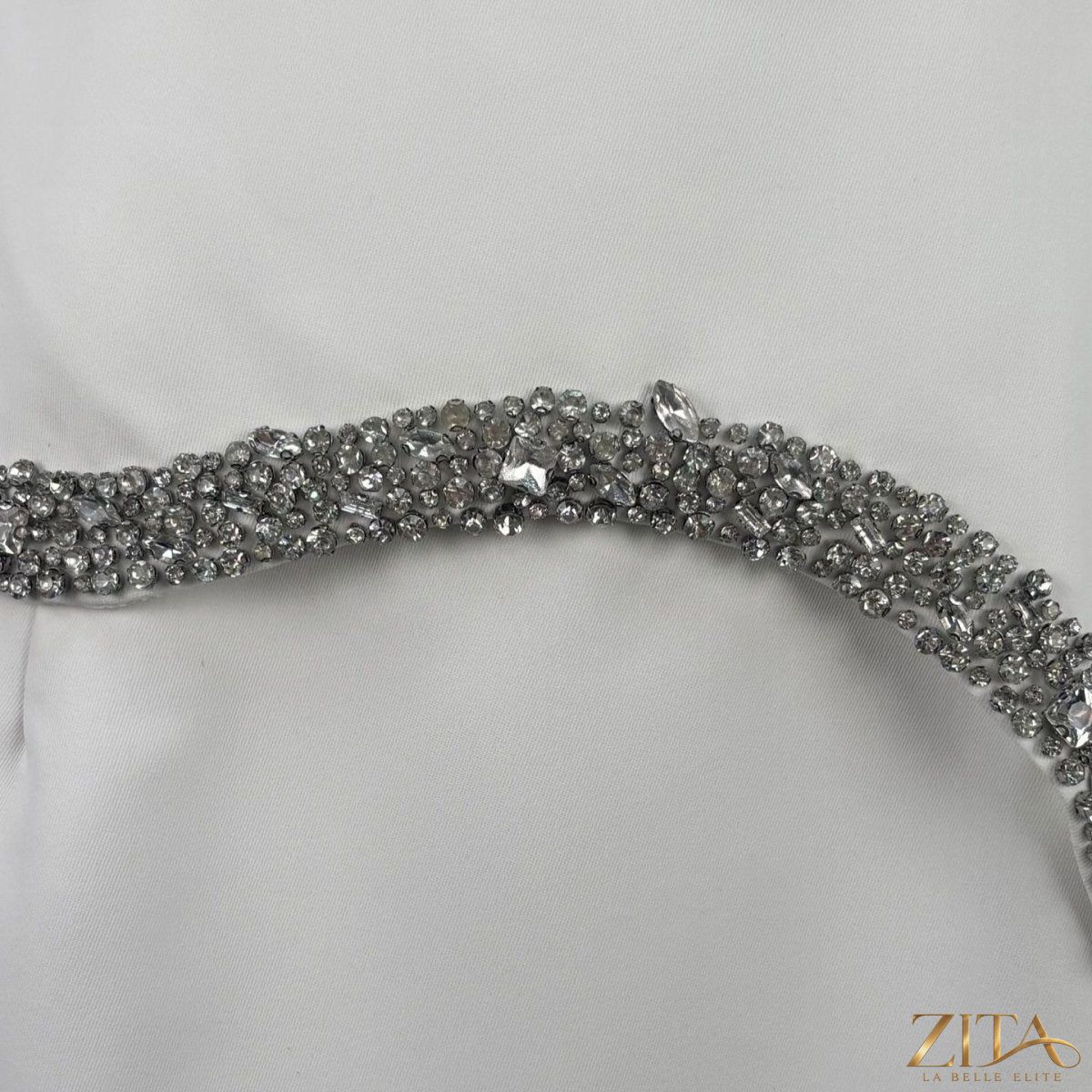 Crystal-embellished evening gown by Zita La Belle Elite featuring intricate crystal details and elegant flowing fabric.