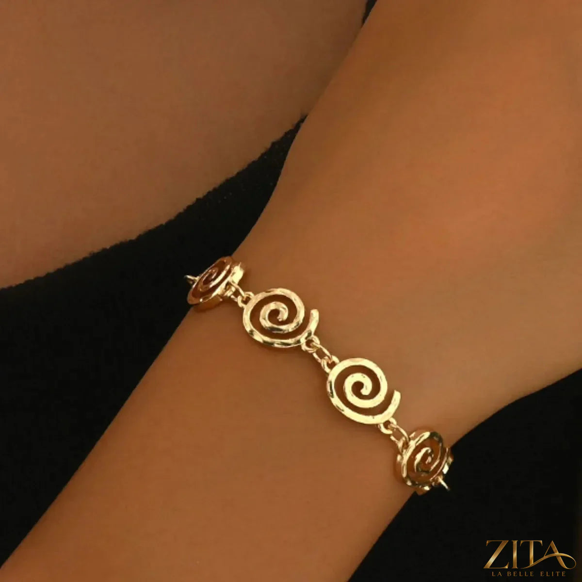 18K gold-plated spiral necklace and bracelet jewelry set featuring sleek, intertwined designs on a white background.